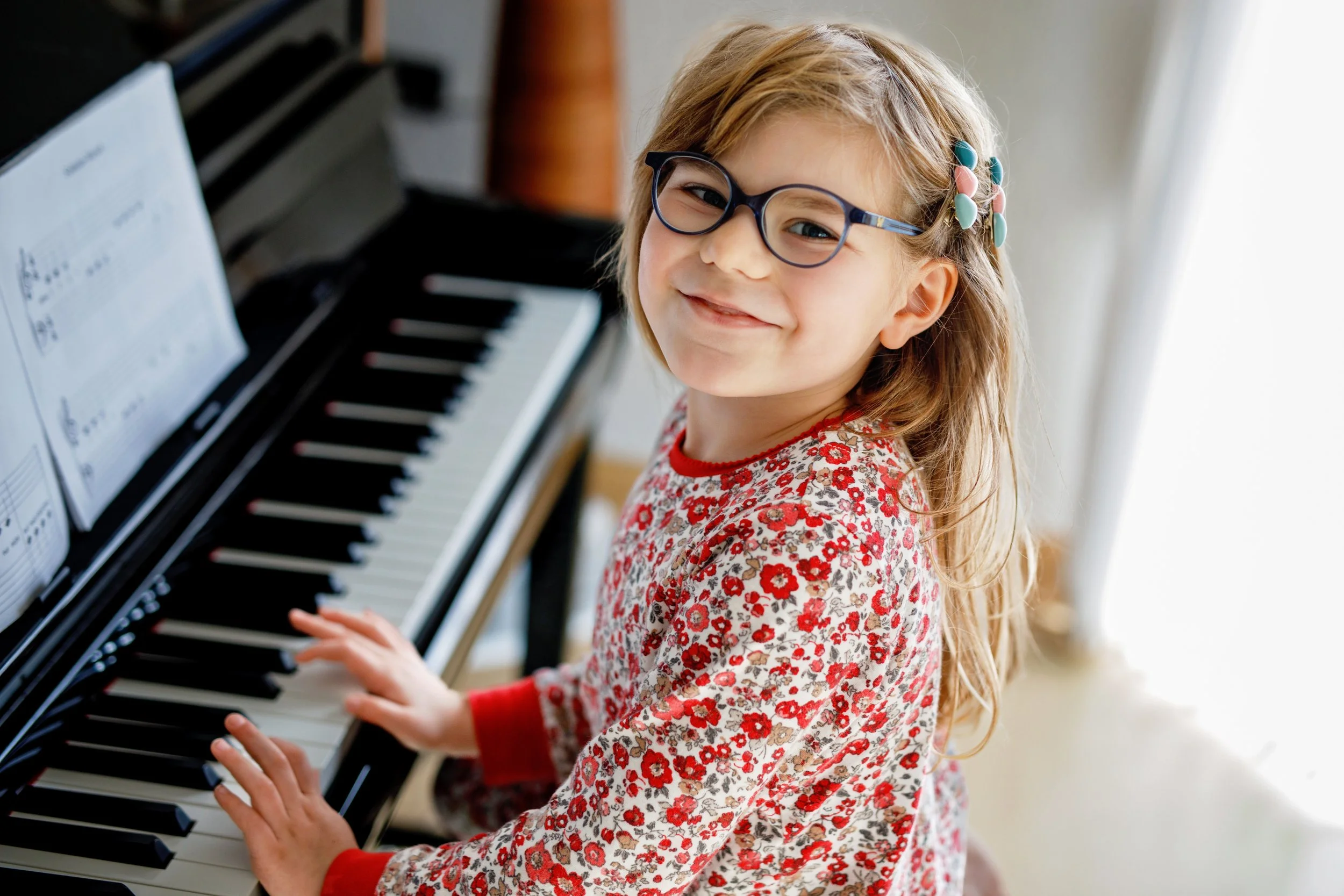 Smiling girl at piano.jpeg