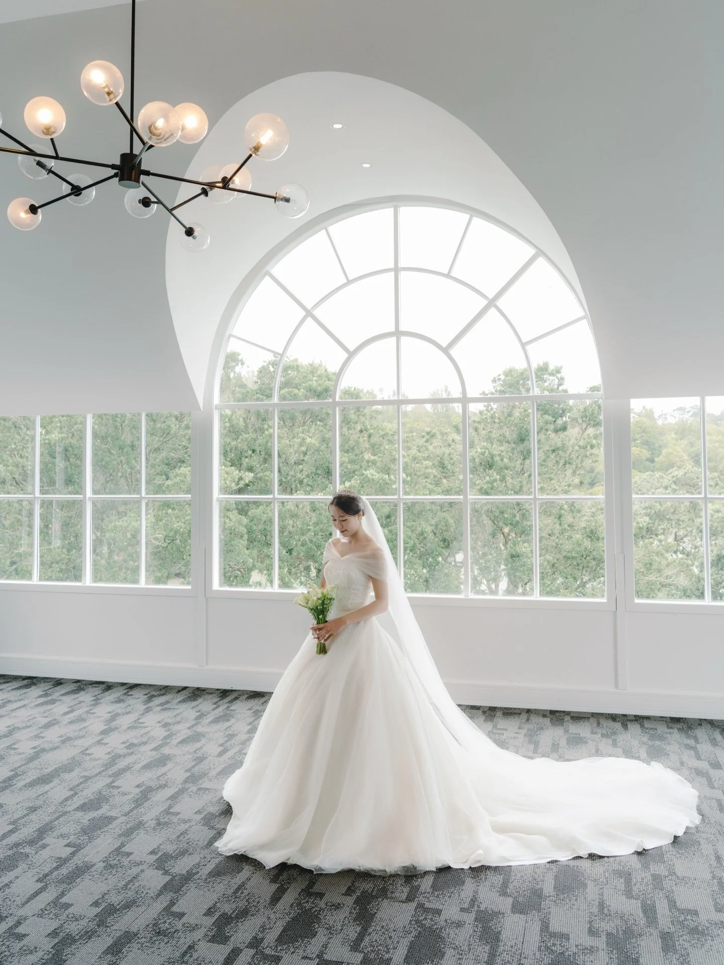 Sophie in the loft - a quiet, moment before it all begins.

Tucked just minutes from the CBD yet feeling a world away, Ōrākei Bay has the perfect place to get ready onsite. Floor-to-ceiling windows flood the space with soft natural light, overlooking