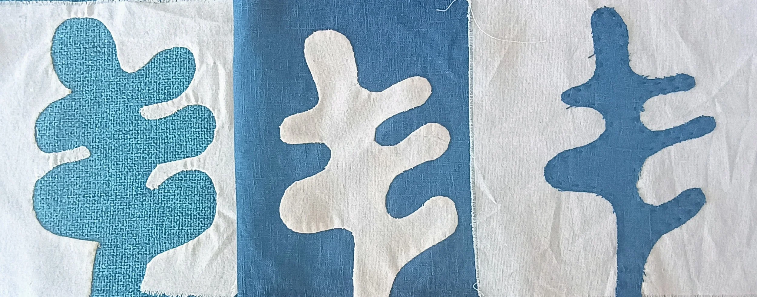 Three blue-colored cactus-shaped designs on white background.