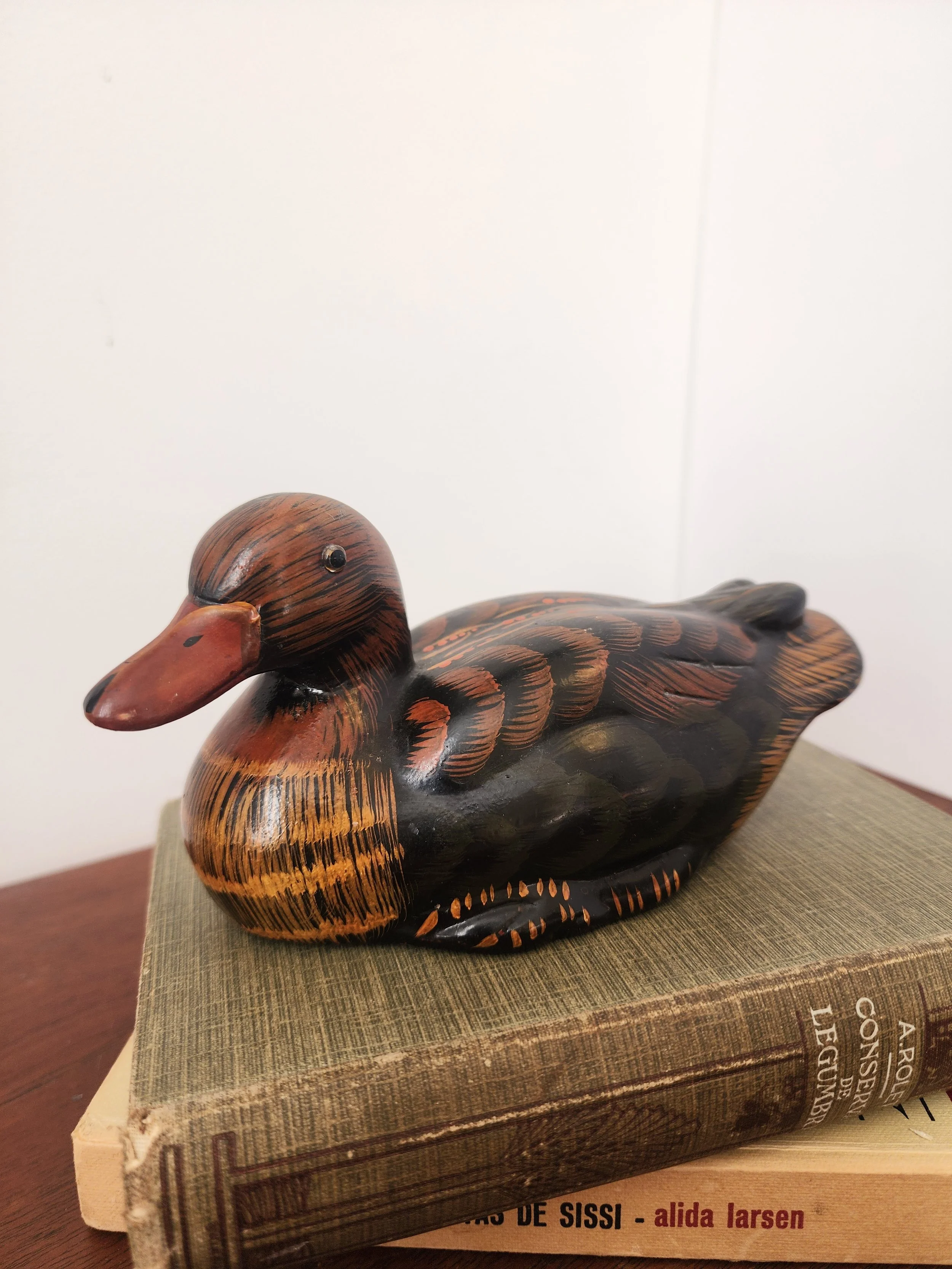 “Rustic hand-painted ceramic duck ornament photographed against a neutral background.”