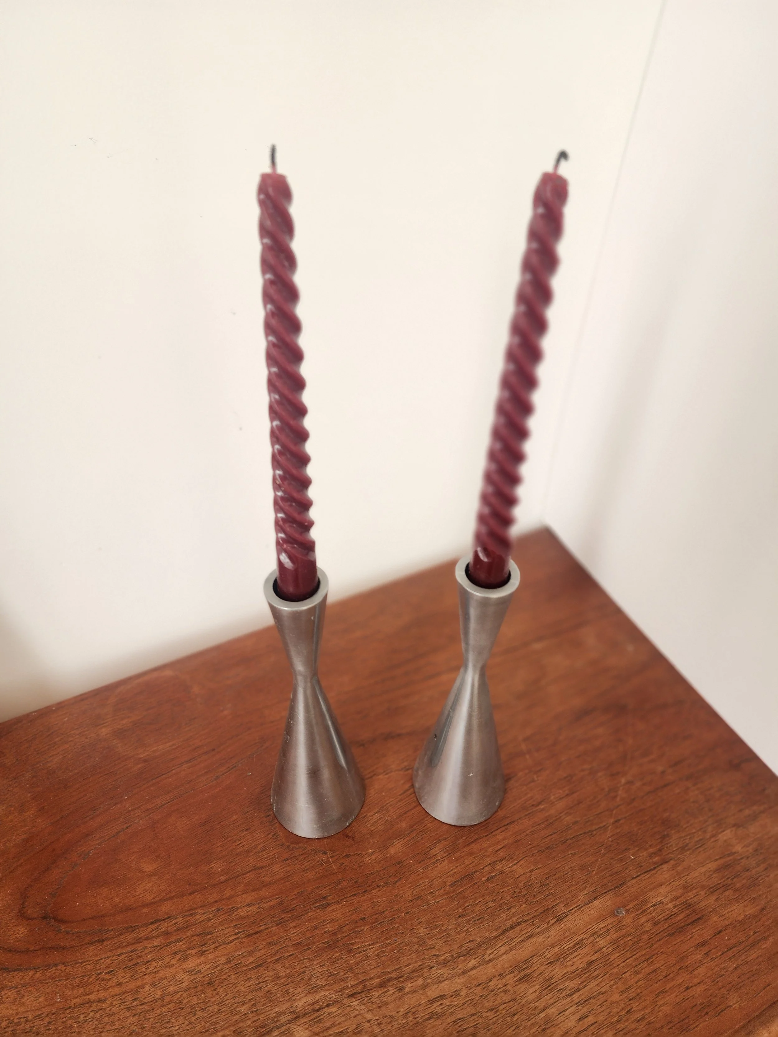 “Minimalist silver candle holder pair styled on a neutral background with linen fabric.”