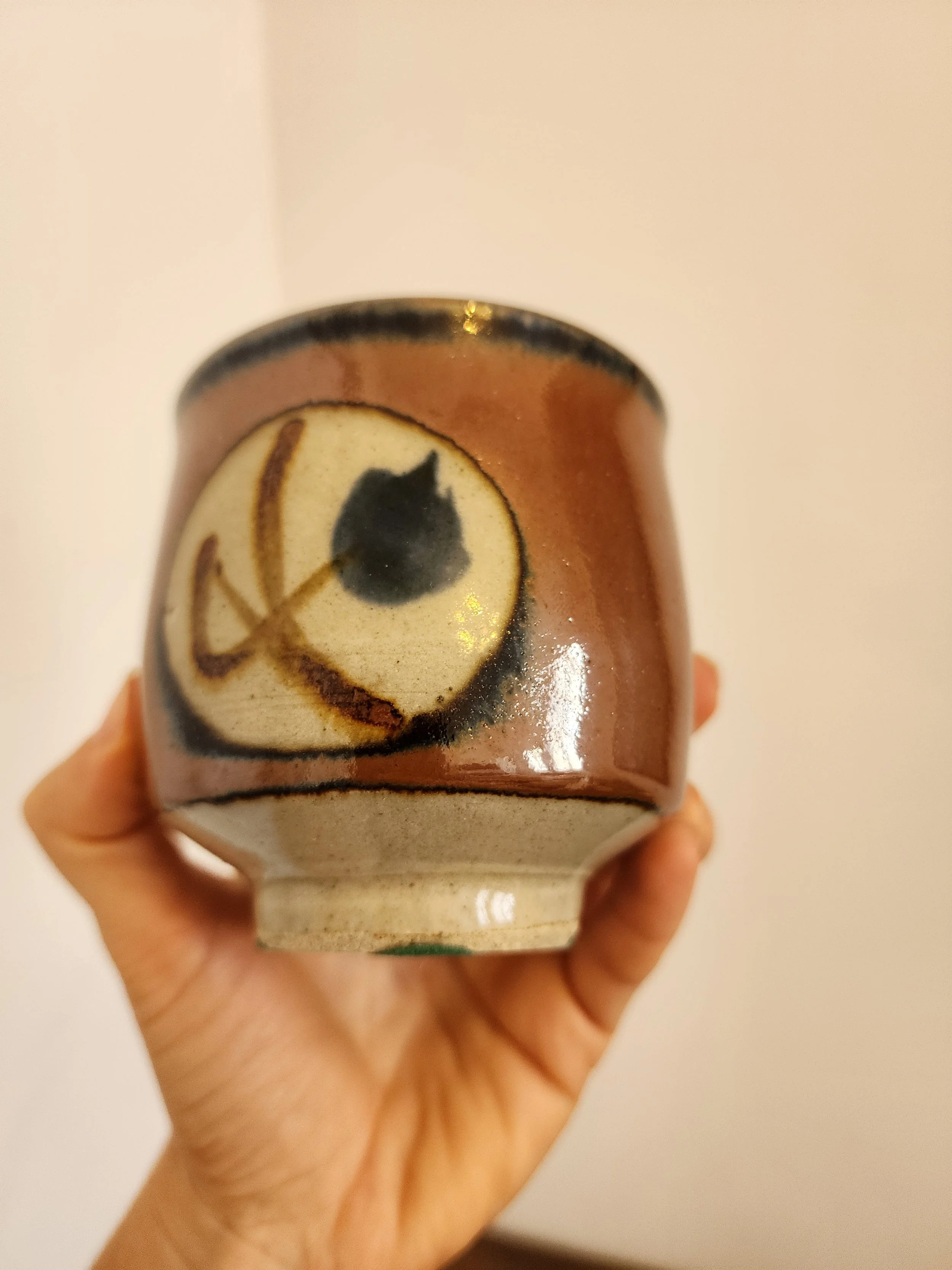 Close-up of rim and glaze transition with earthy tones.