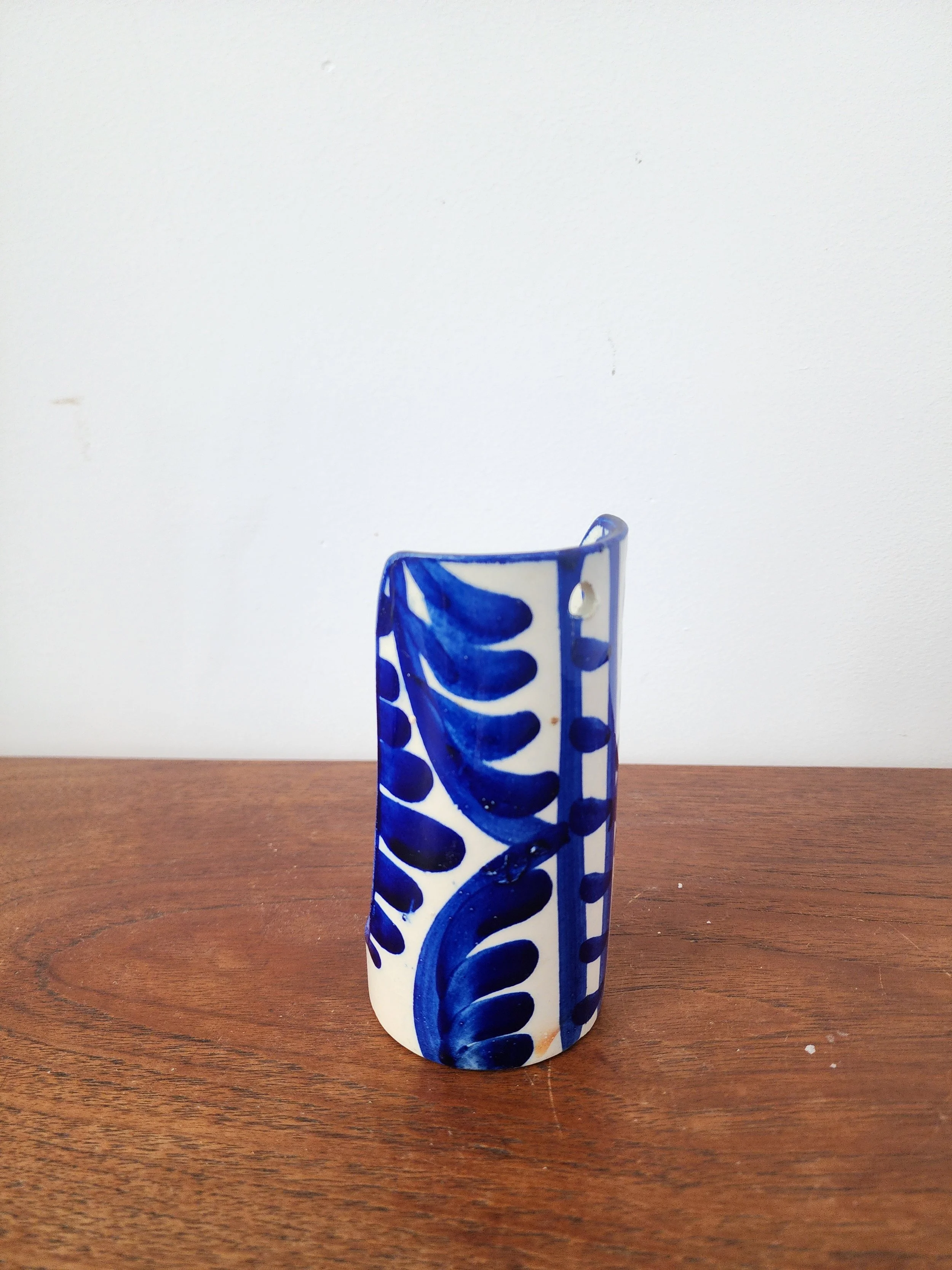 Vintage ceramic candle holder styled with red twisted candle.