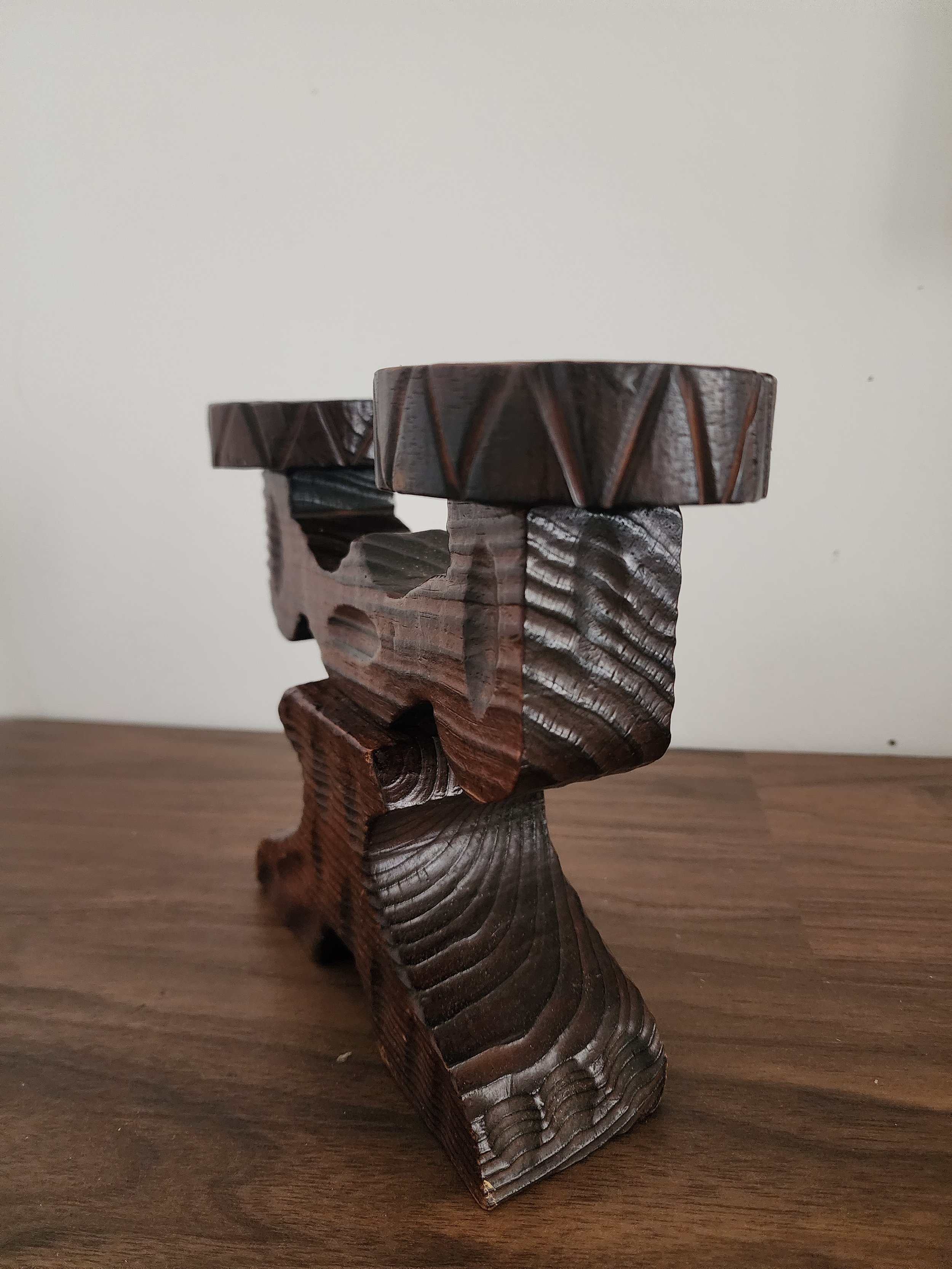 Close-up of carved details and stained wood texture.