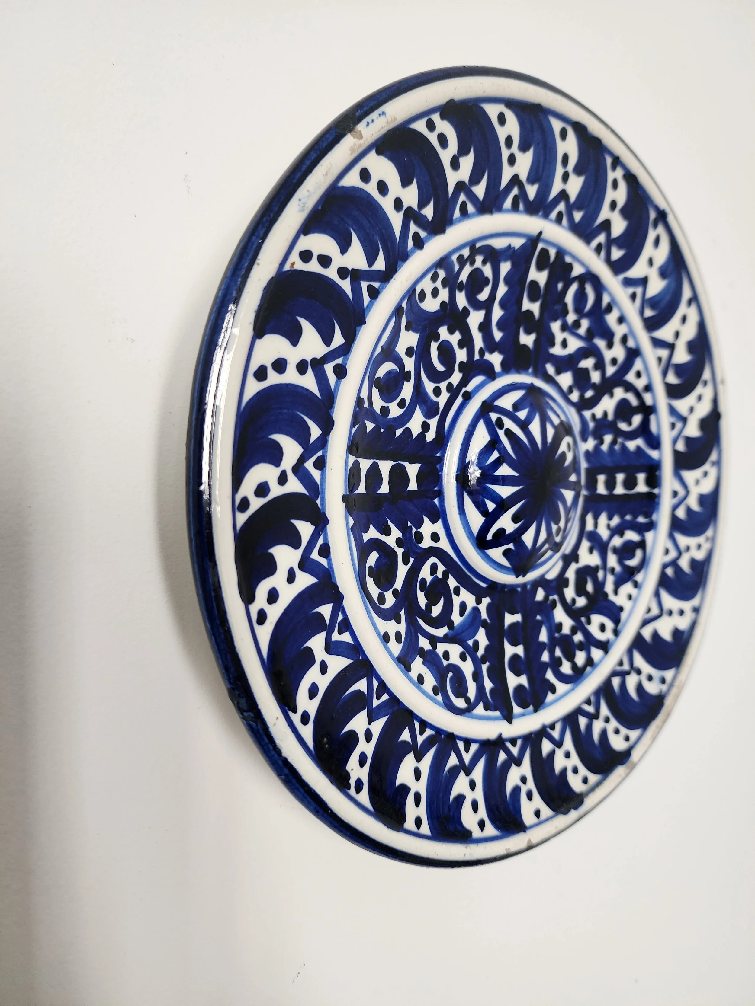 Mediterranean-style decorative plates in cobalt blue pattern.