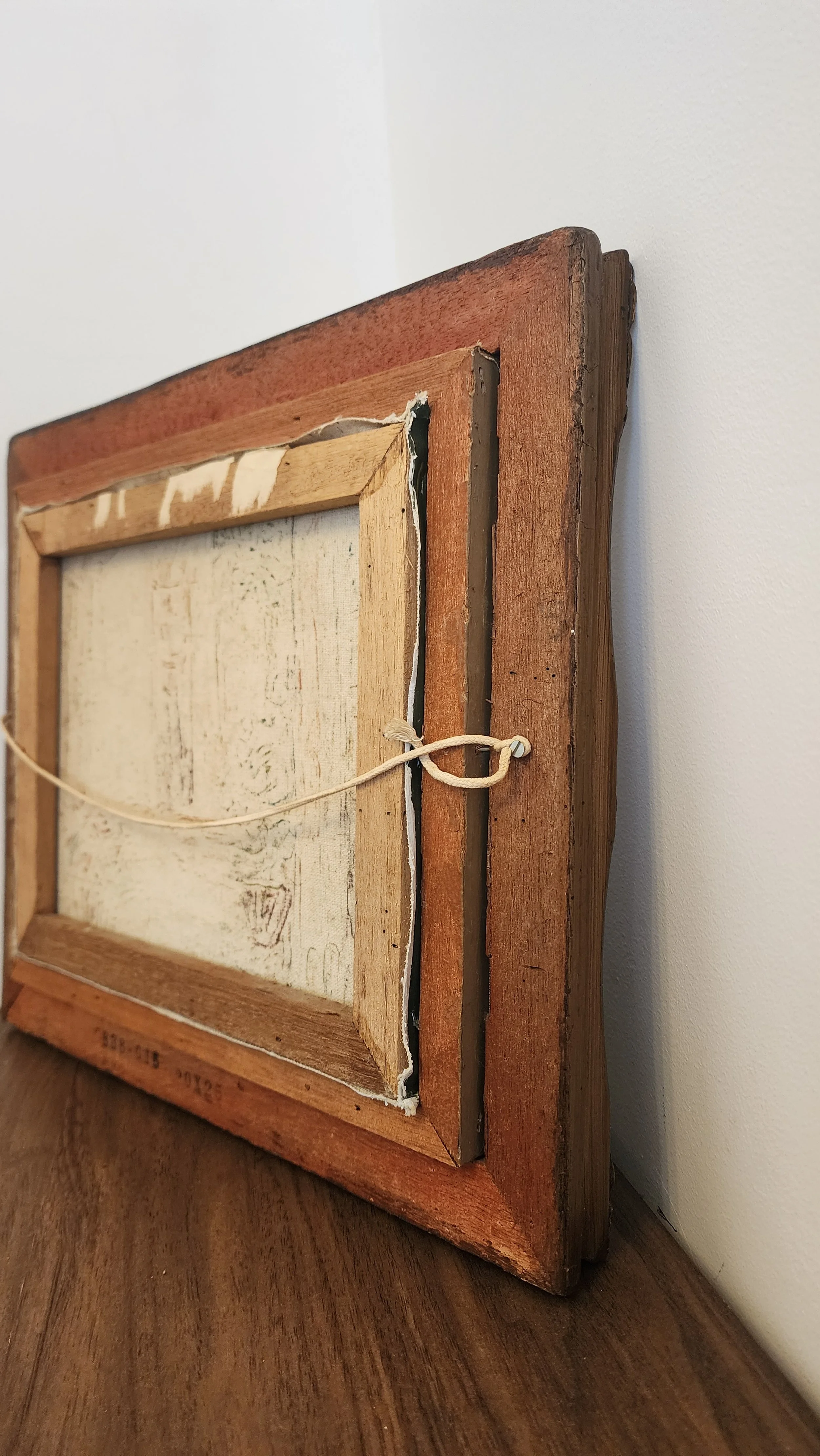 Back of frame showing hanging hardware and original board.