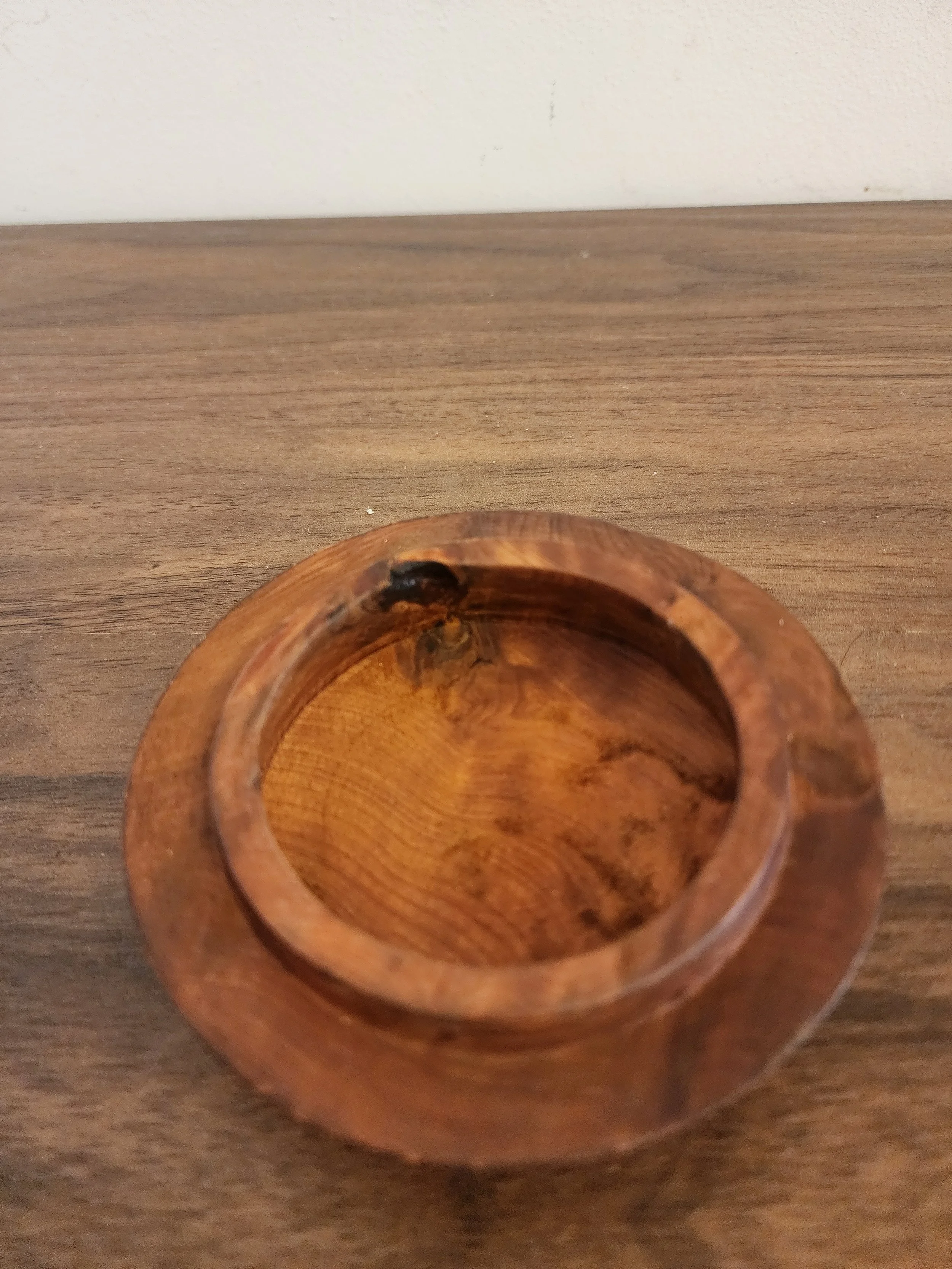 Box with lid slightly open revealing interior depth.