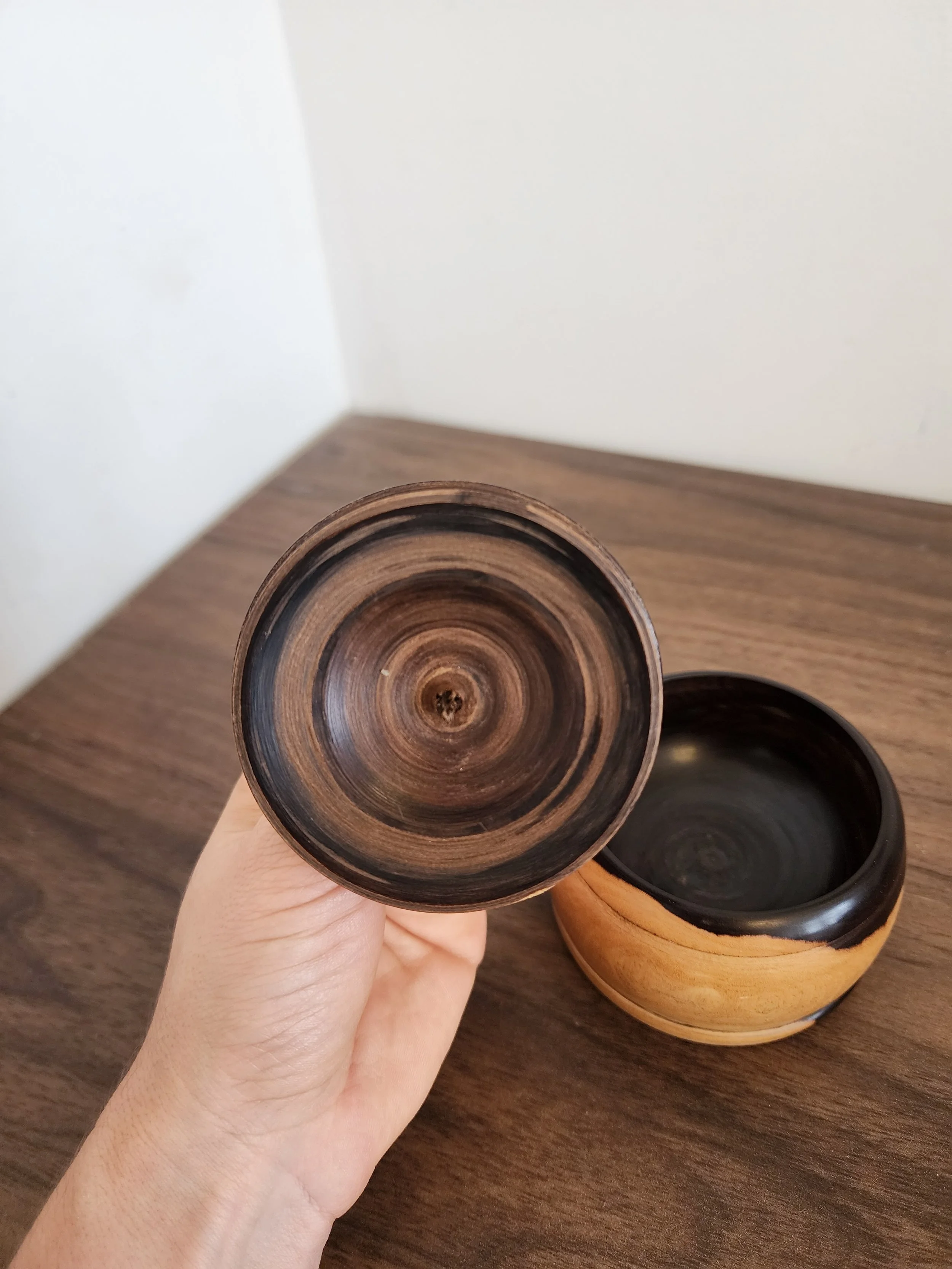 Top-down view of vintage wooden lidded container for kitchen or decor.