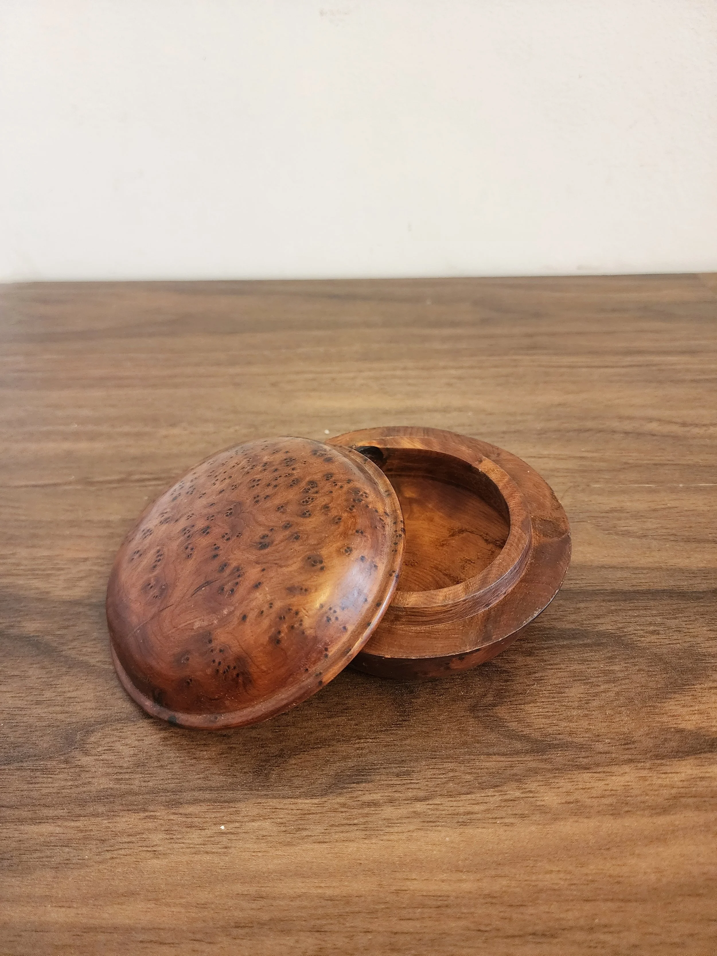 Overhead view of wooden box showing circular grain pattern.