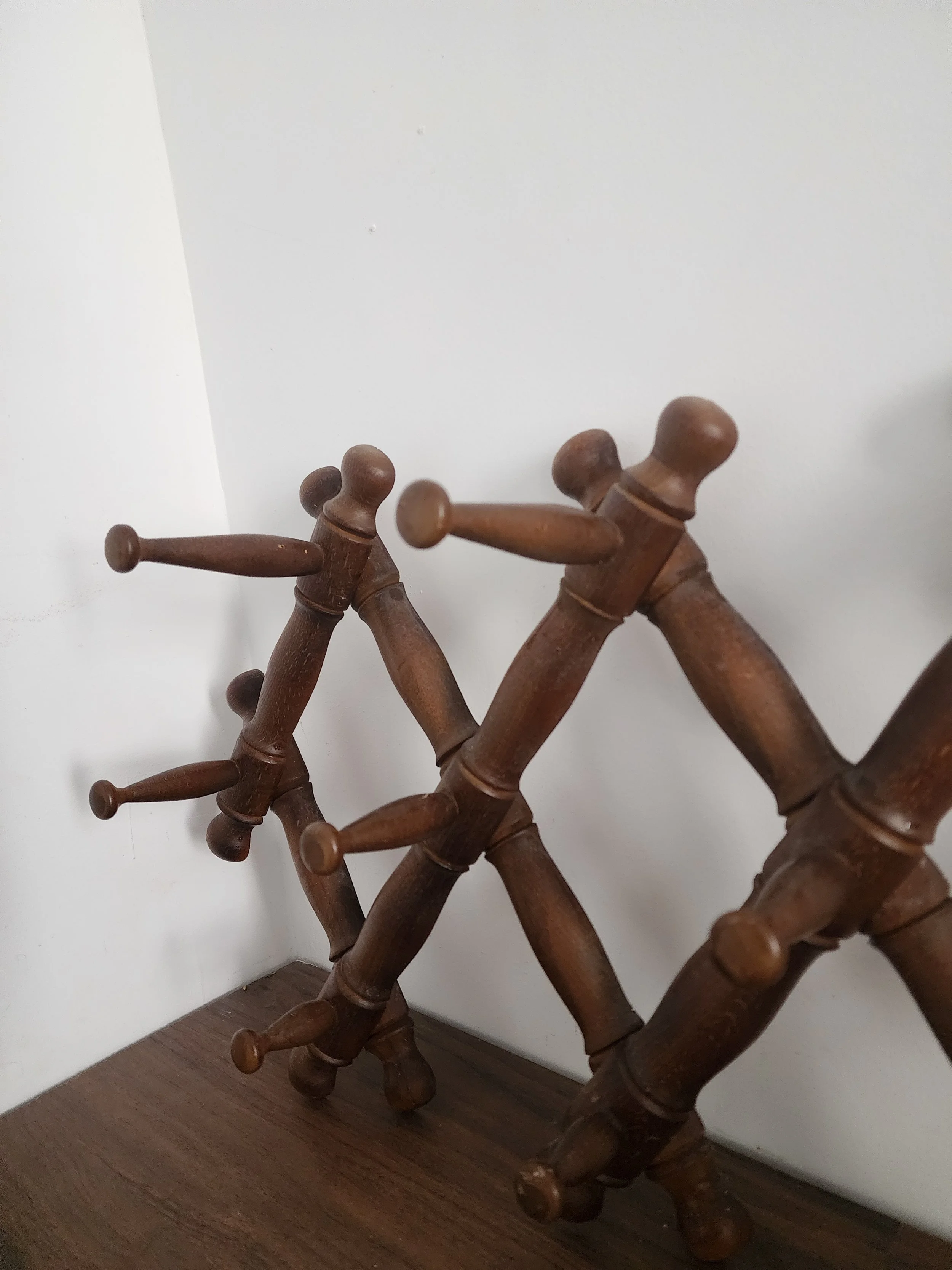 Rustic wooden wall hanger displayed against beige background.