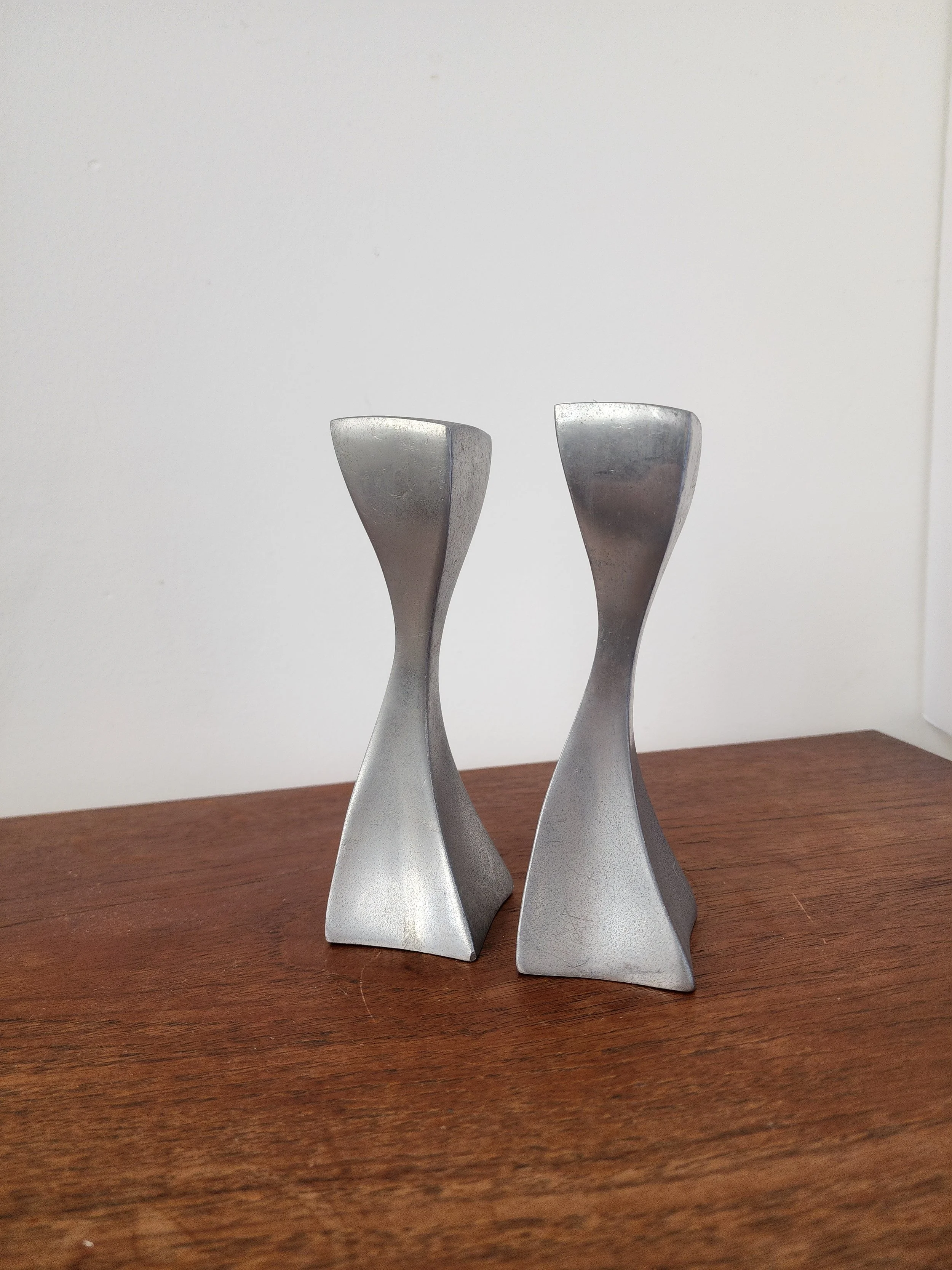 Pair of vintage modernist metal candlesticks with twisted sculptural shape.