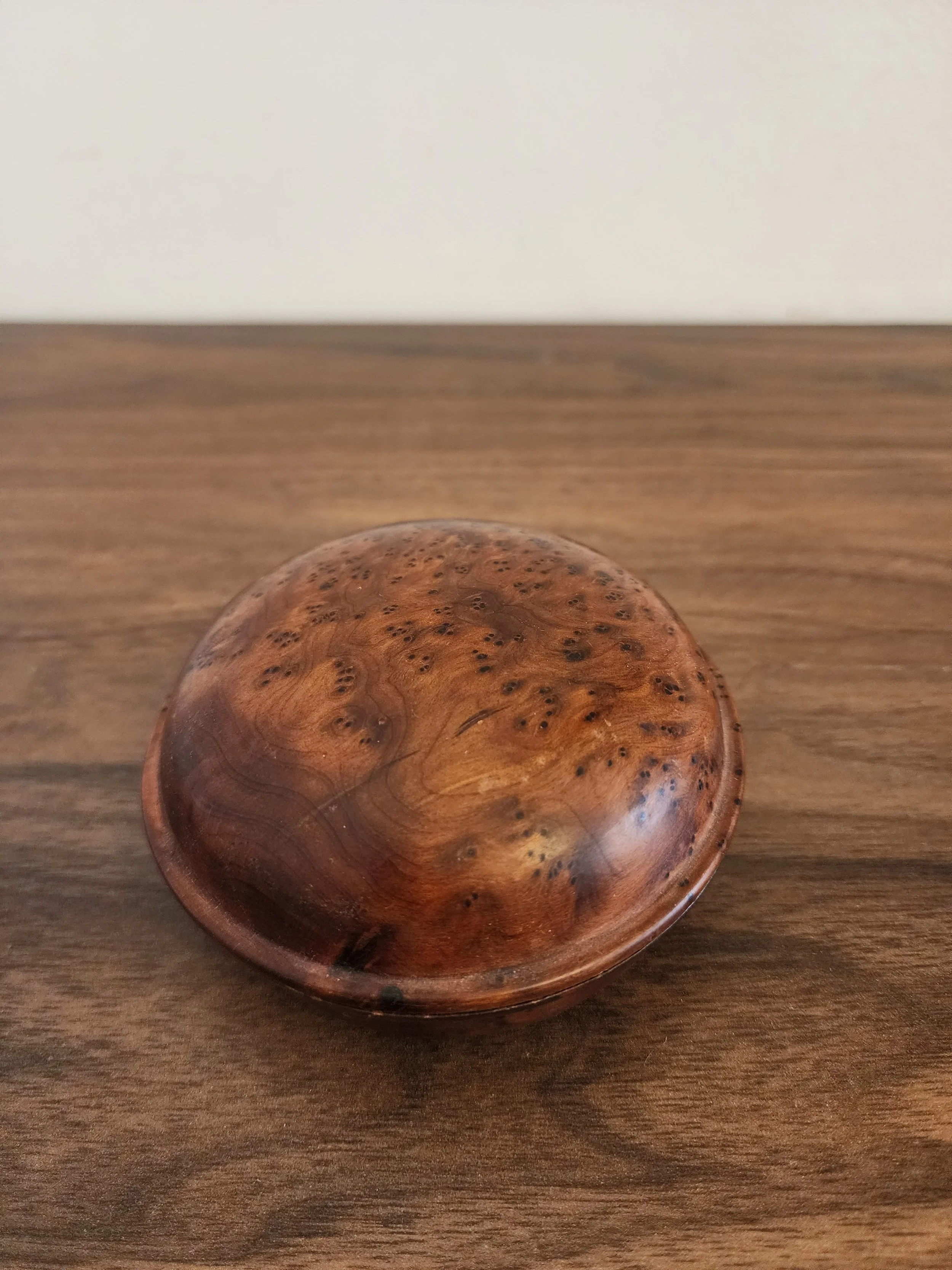 Side angle showing domed lid and rounded base.