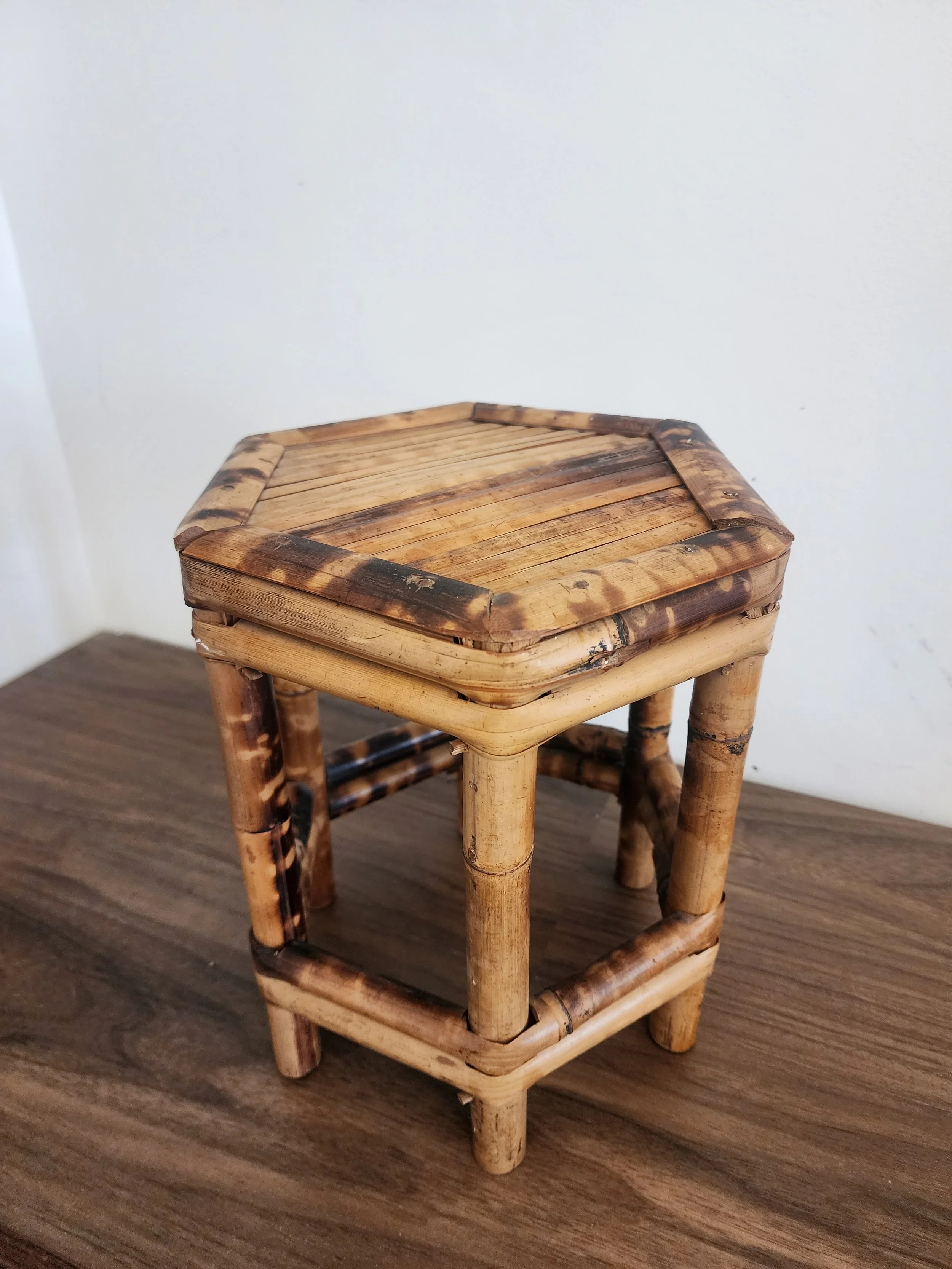 side view of burnt bamboo stool showing traditional joinery