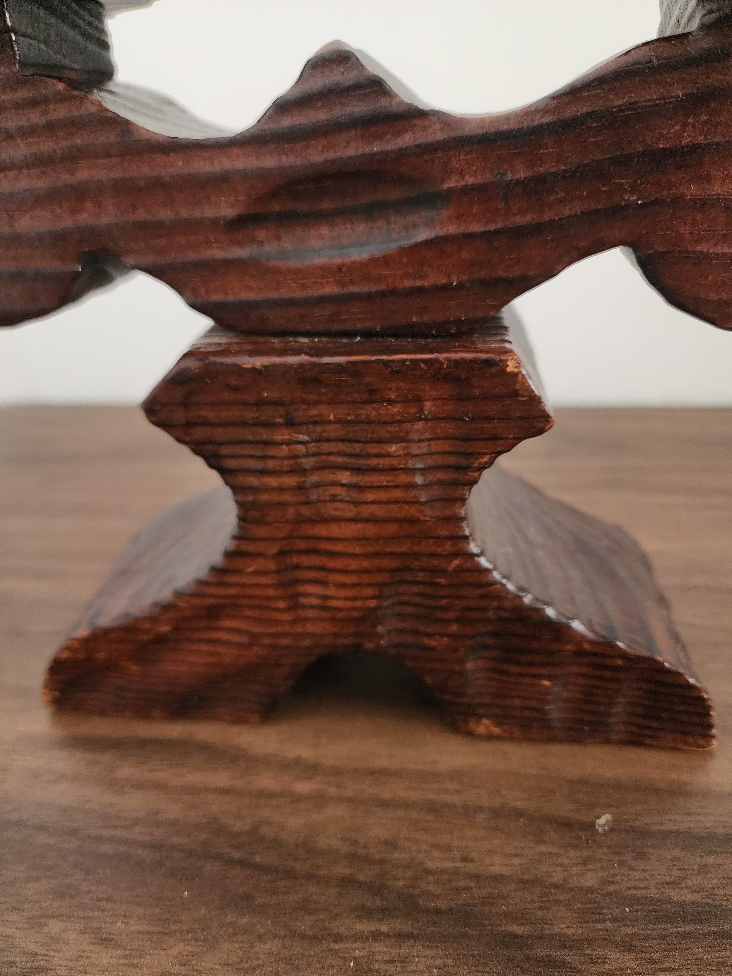 Detail of base carvings showing craftsmanship and grain.