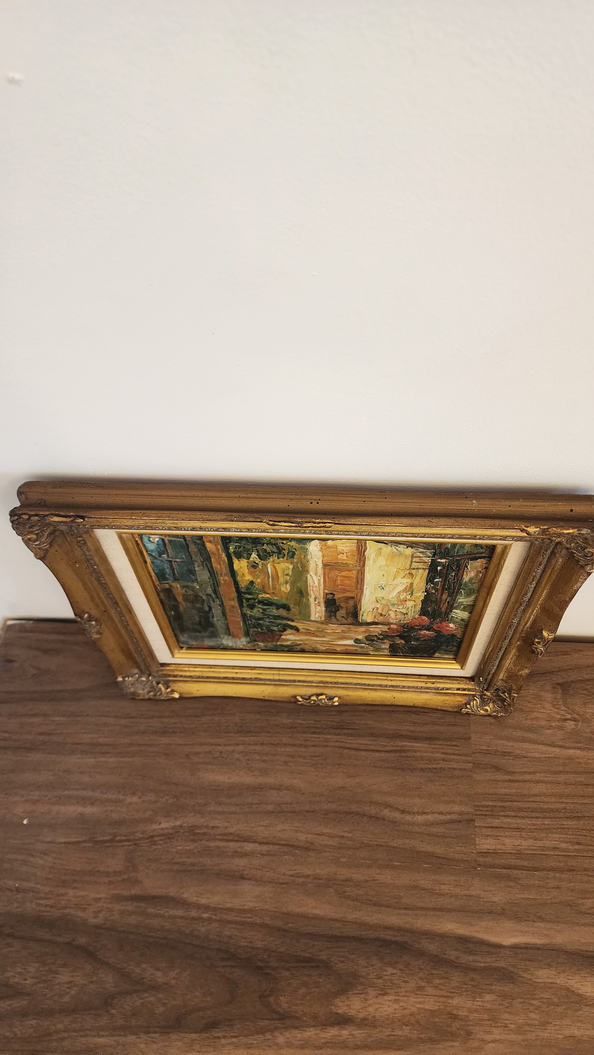 Framed painting hanging on wall in attention-grabbing vignette.