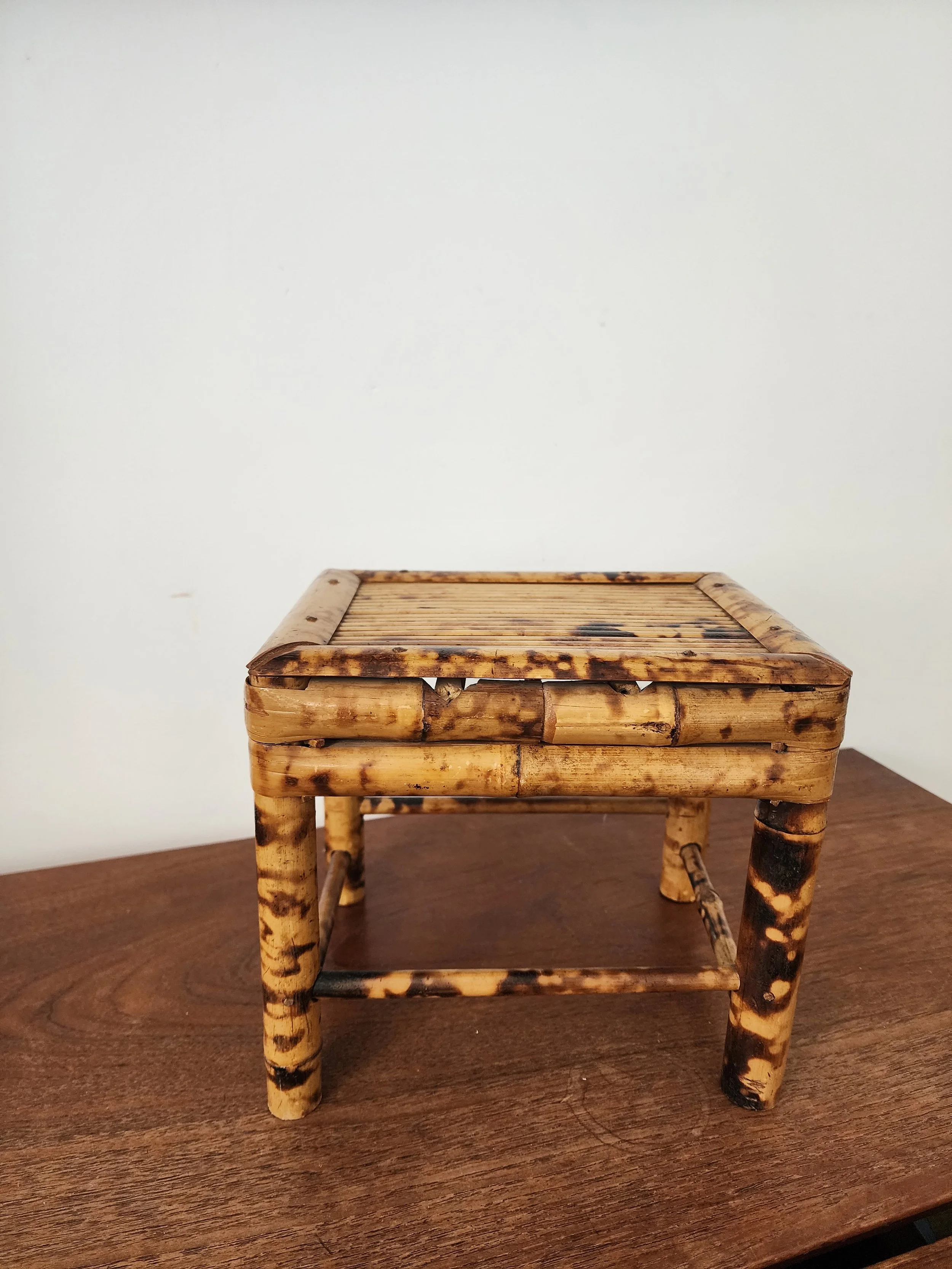 Small rustic bamboo accent table for boho interiors.