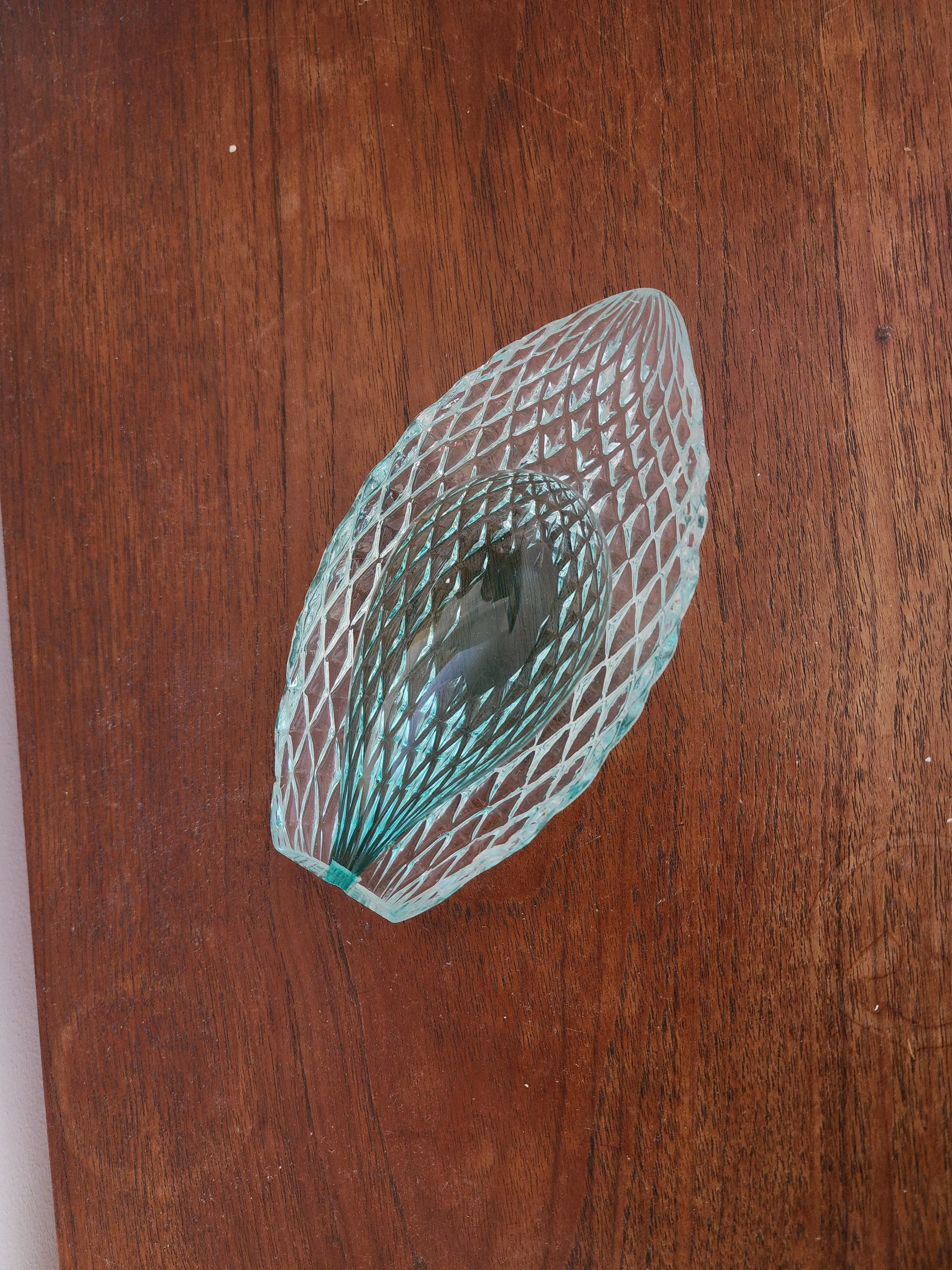 Light blue glass bowl reflecting soft natural light.