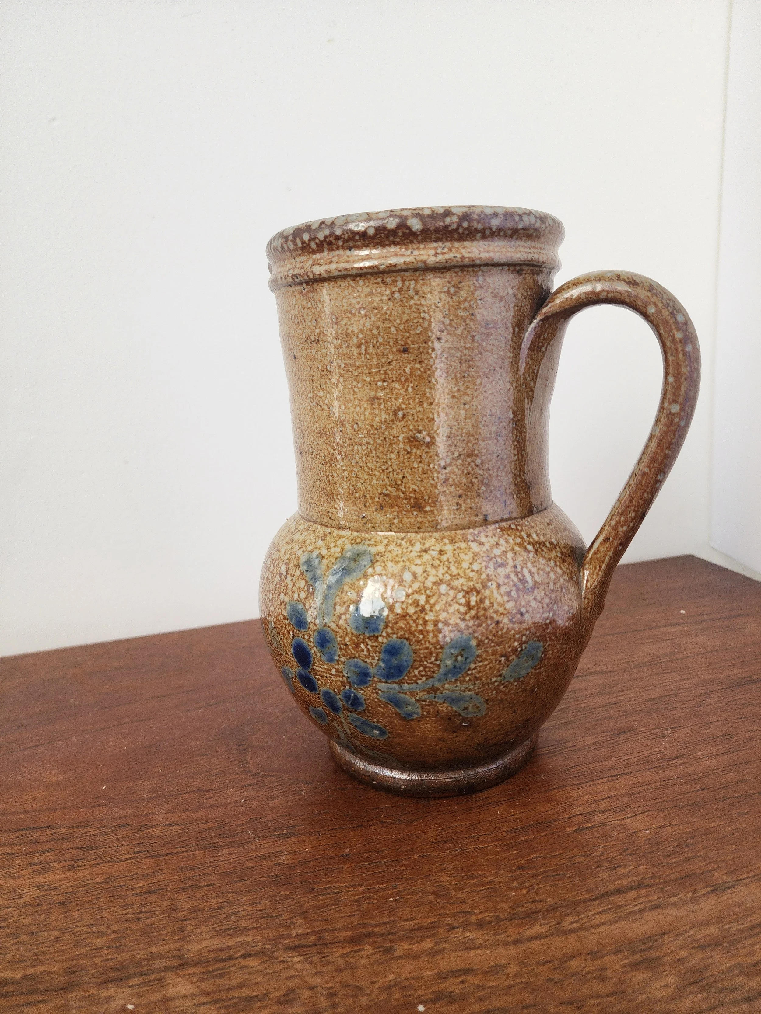 Close-up of floral teal and navy blue pattern on vintage stoneware jug