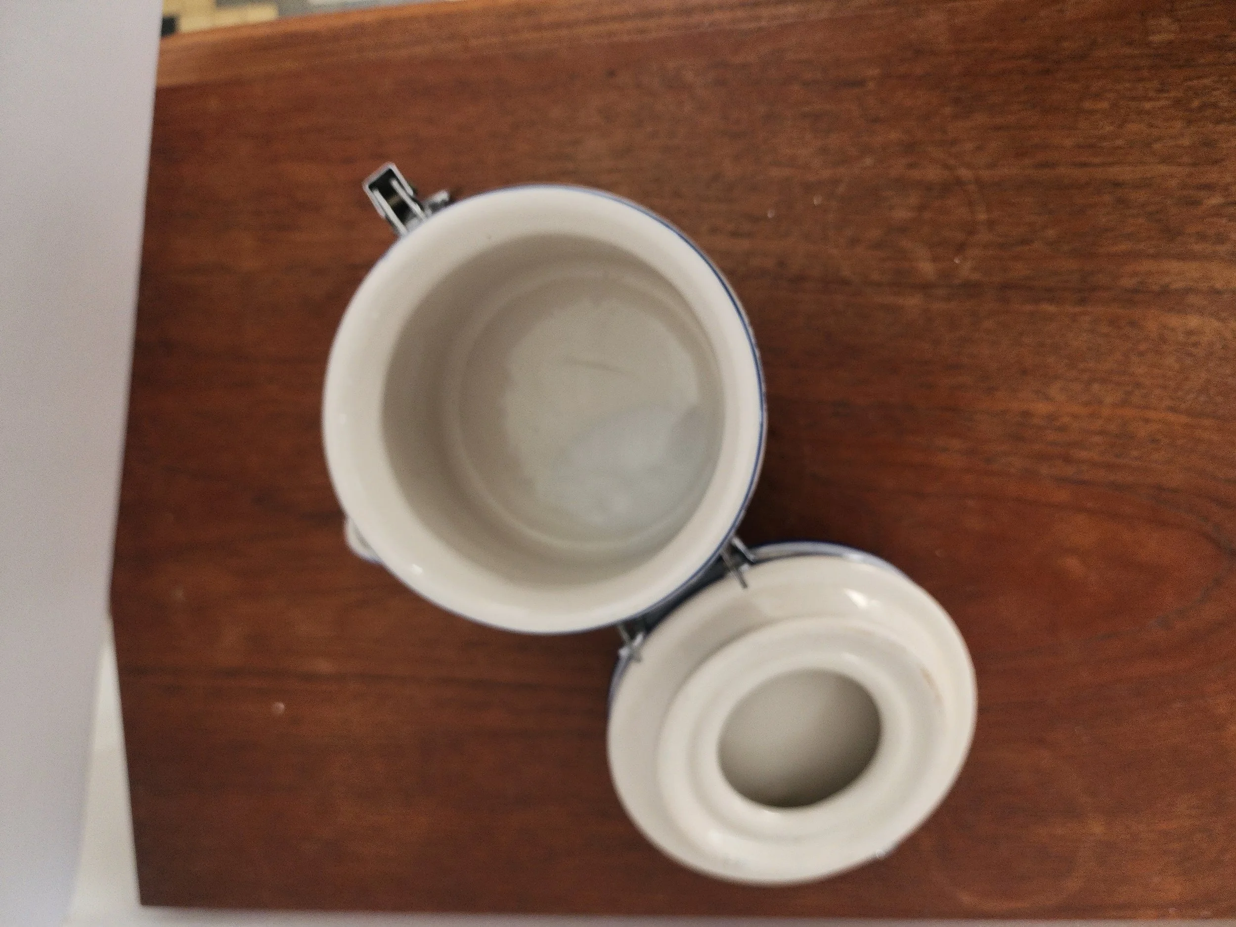 Overhead view of canister with wooden spoon and secure clasp.