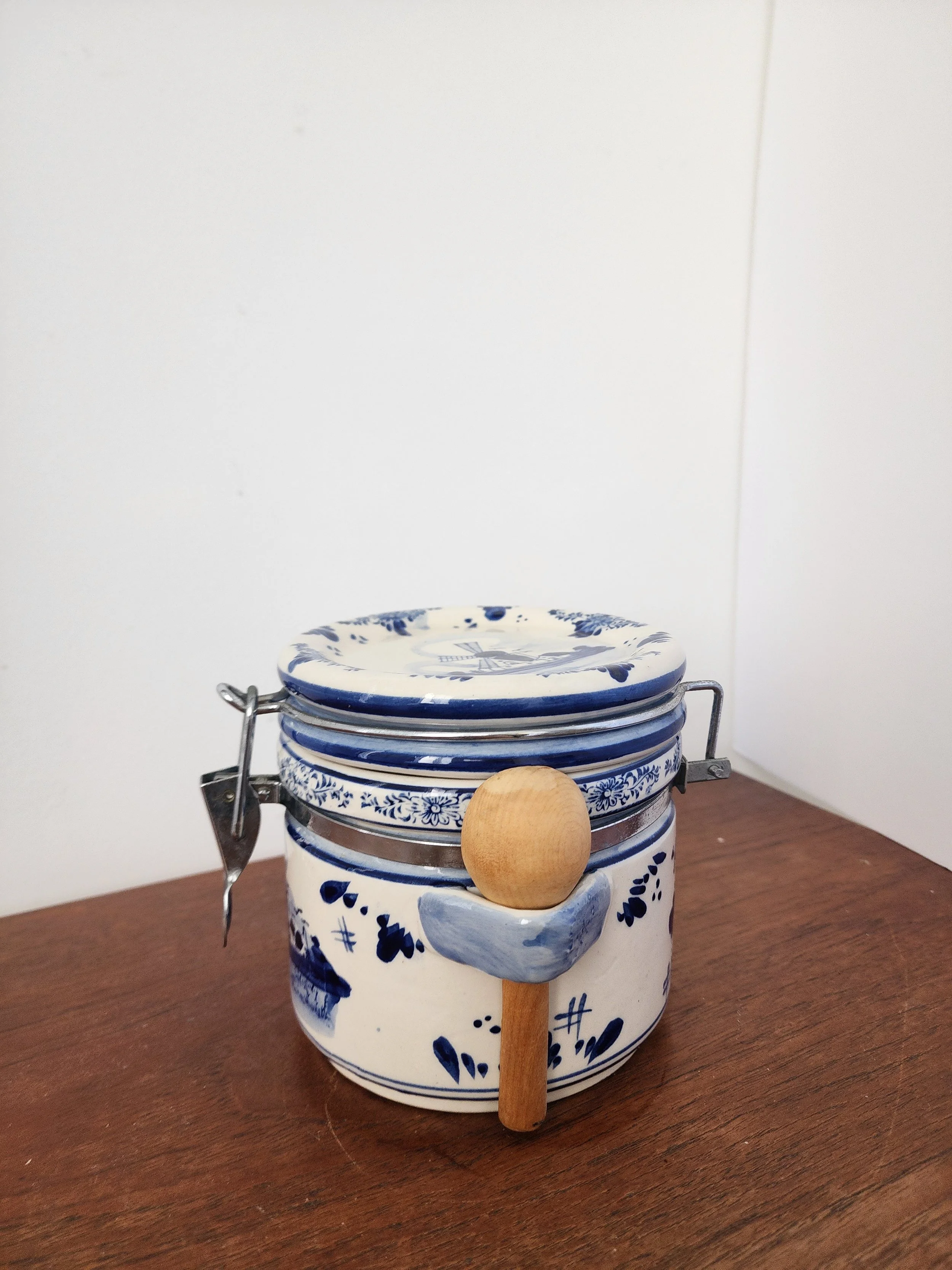 Hand-painted Dutch floral pottery jar with metal clasp.