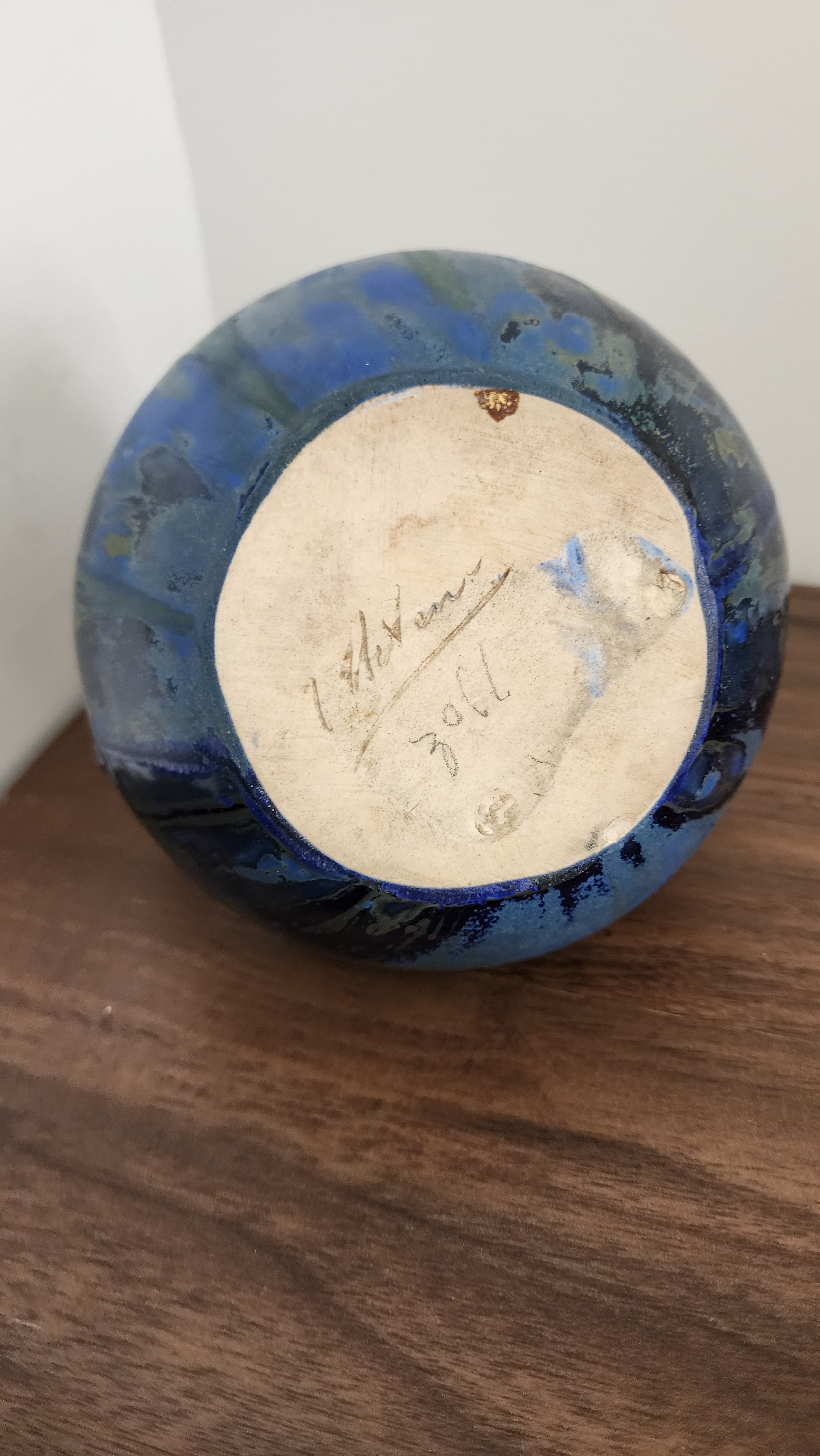 Vase styled in natural light, showcasing reflective Art Deco hues.