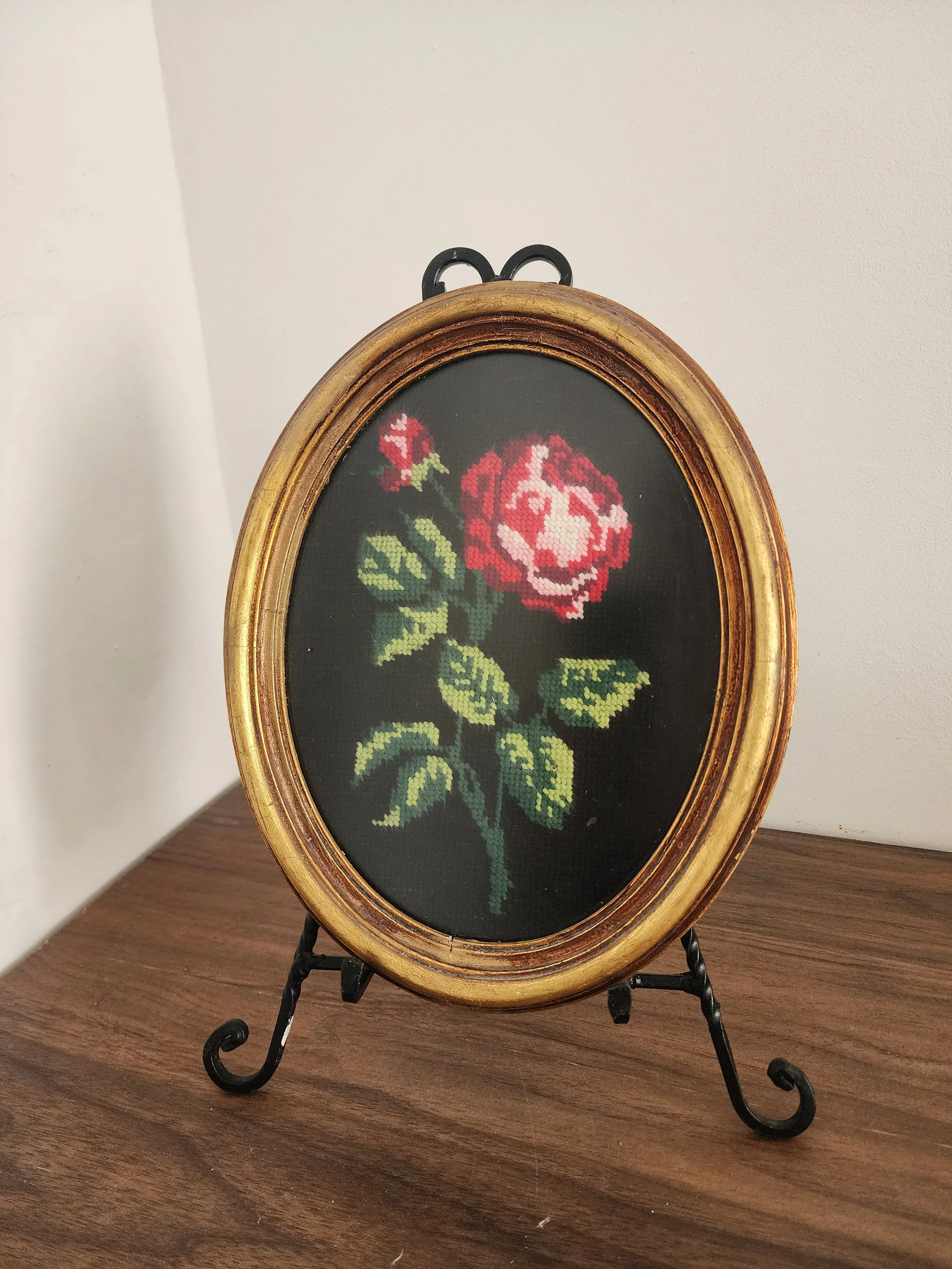 Hand-stitched floral embroidery art in gold frame.