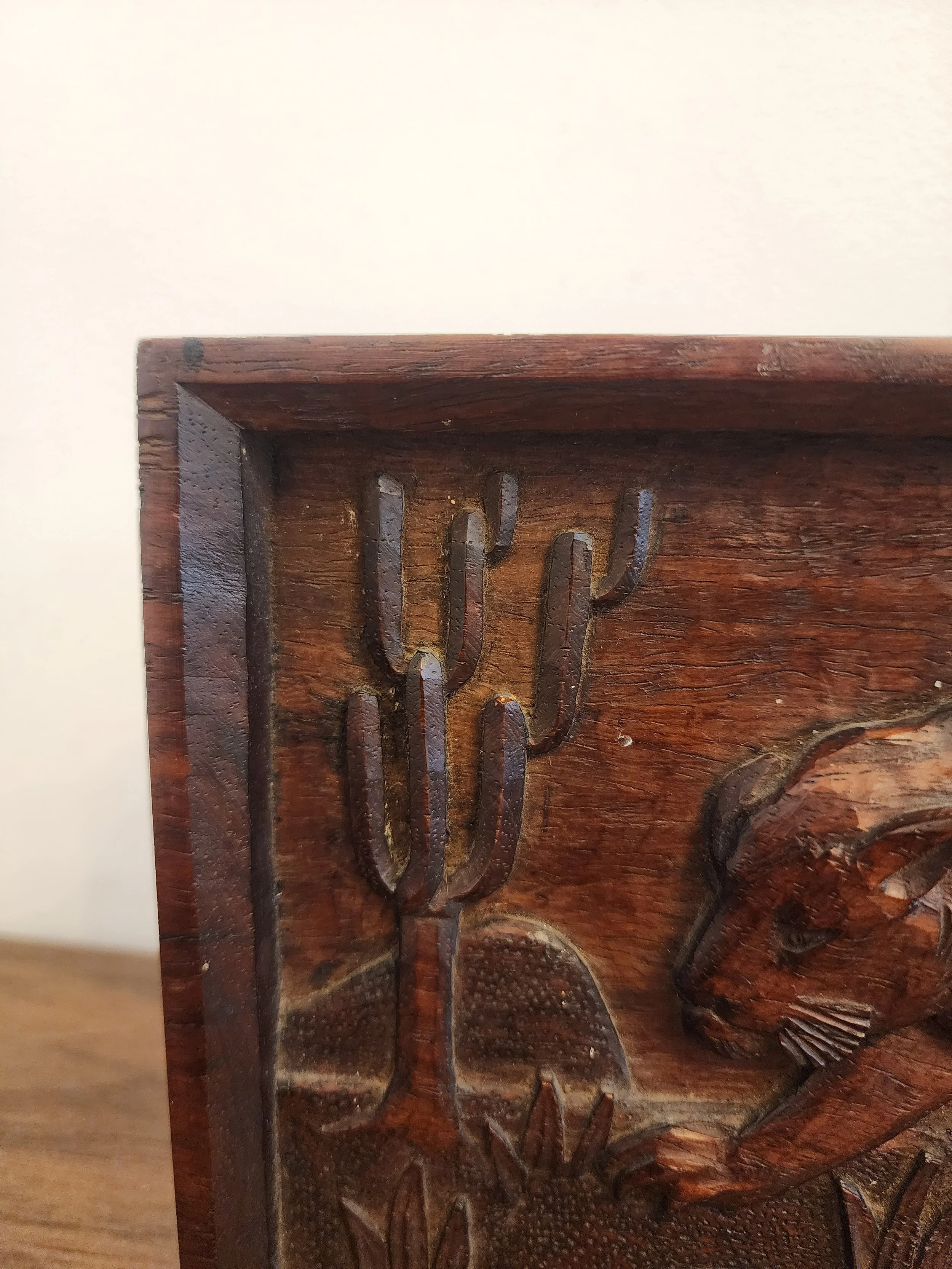 Vintage panther carving on warm brown wood.