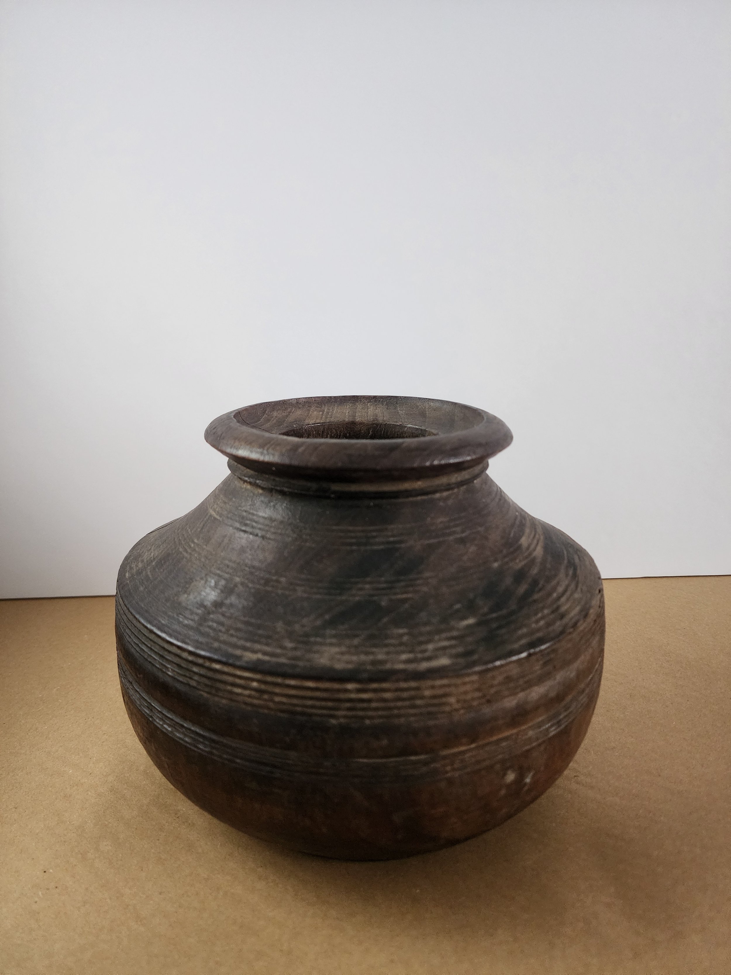 Side angle showing flared rim and turned carved band details.