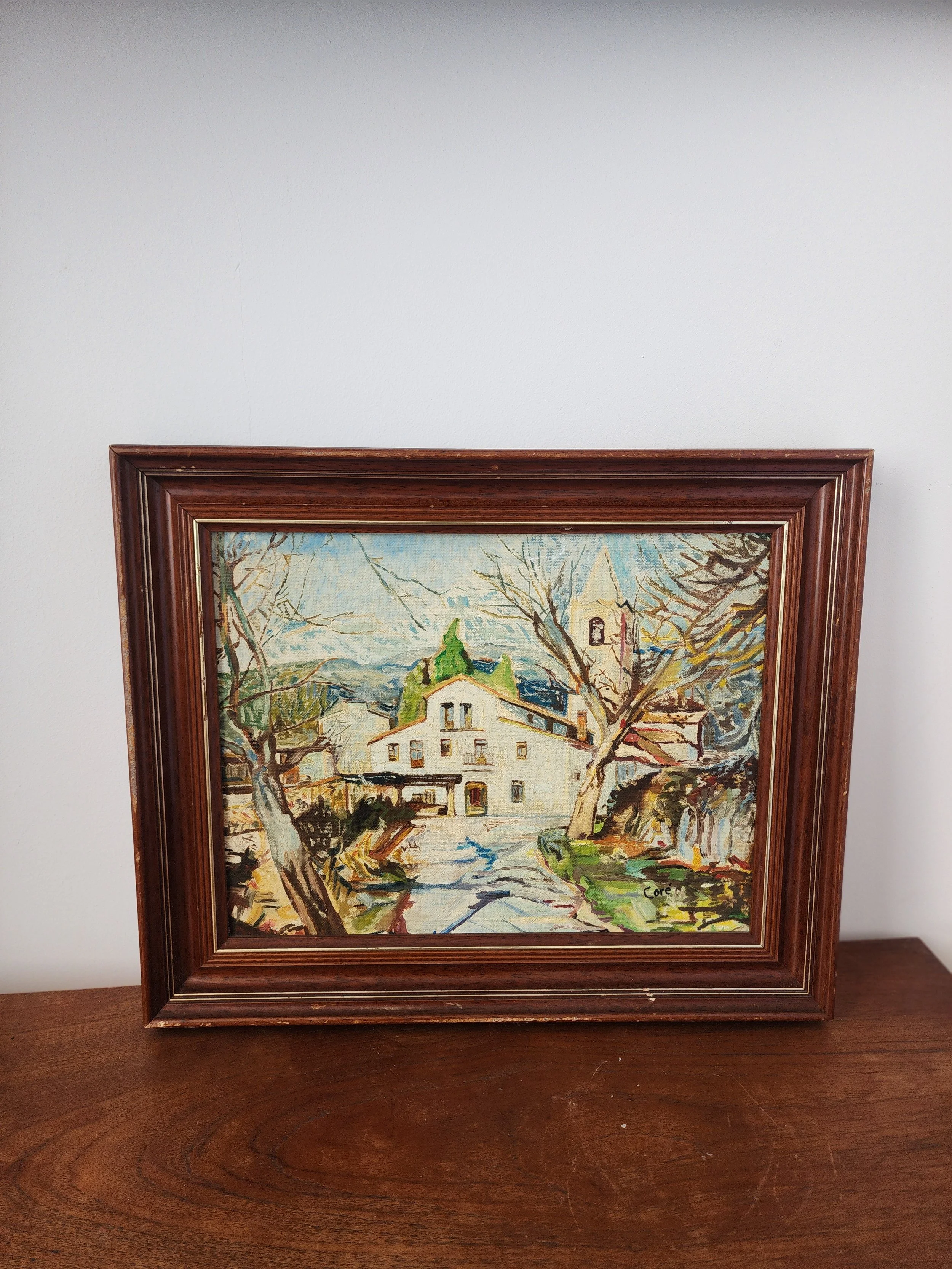 Hand-painted European village scene in wooden frame.