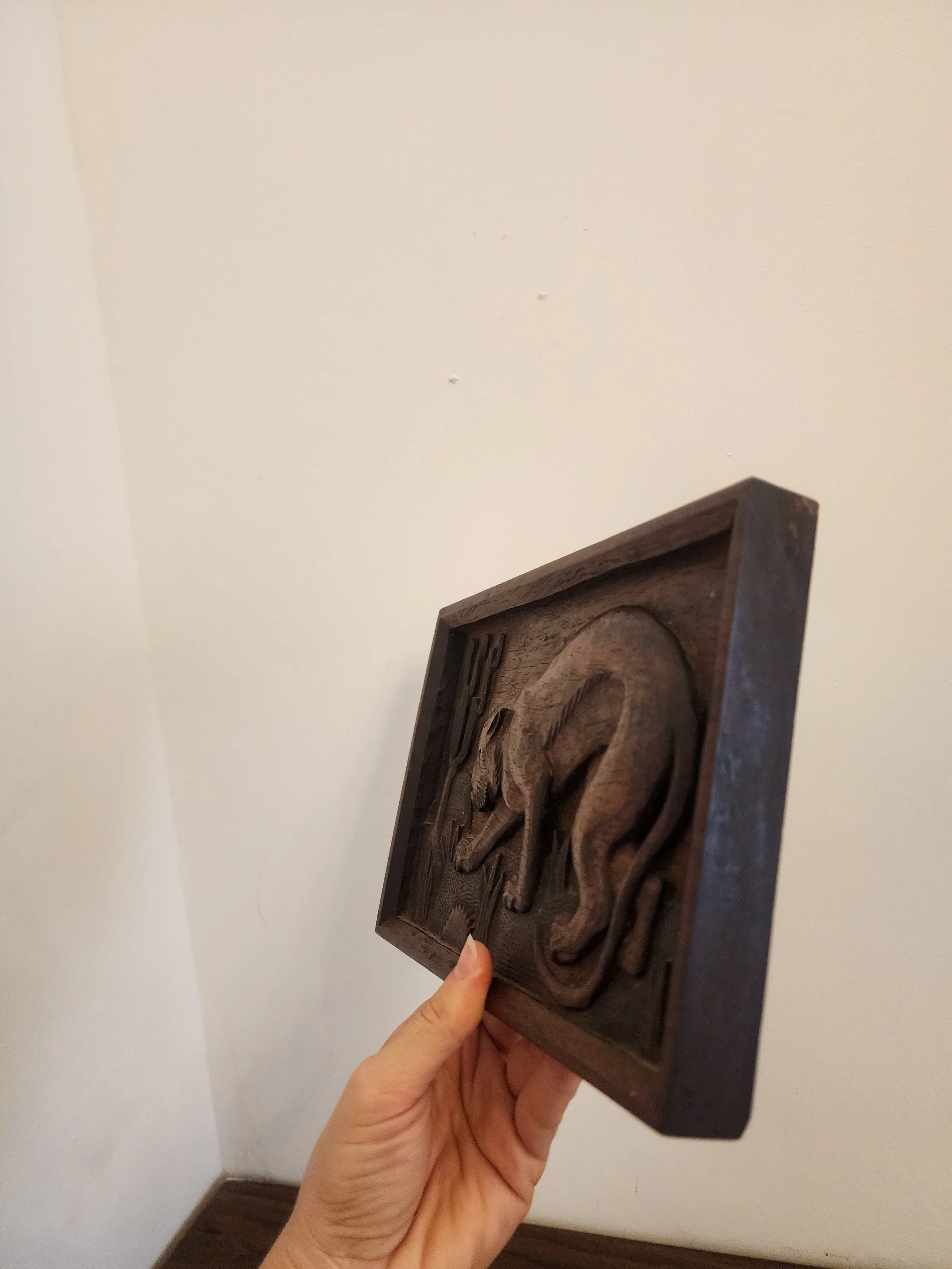 Artisan wooden plaque with desert landscape.