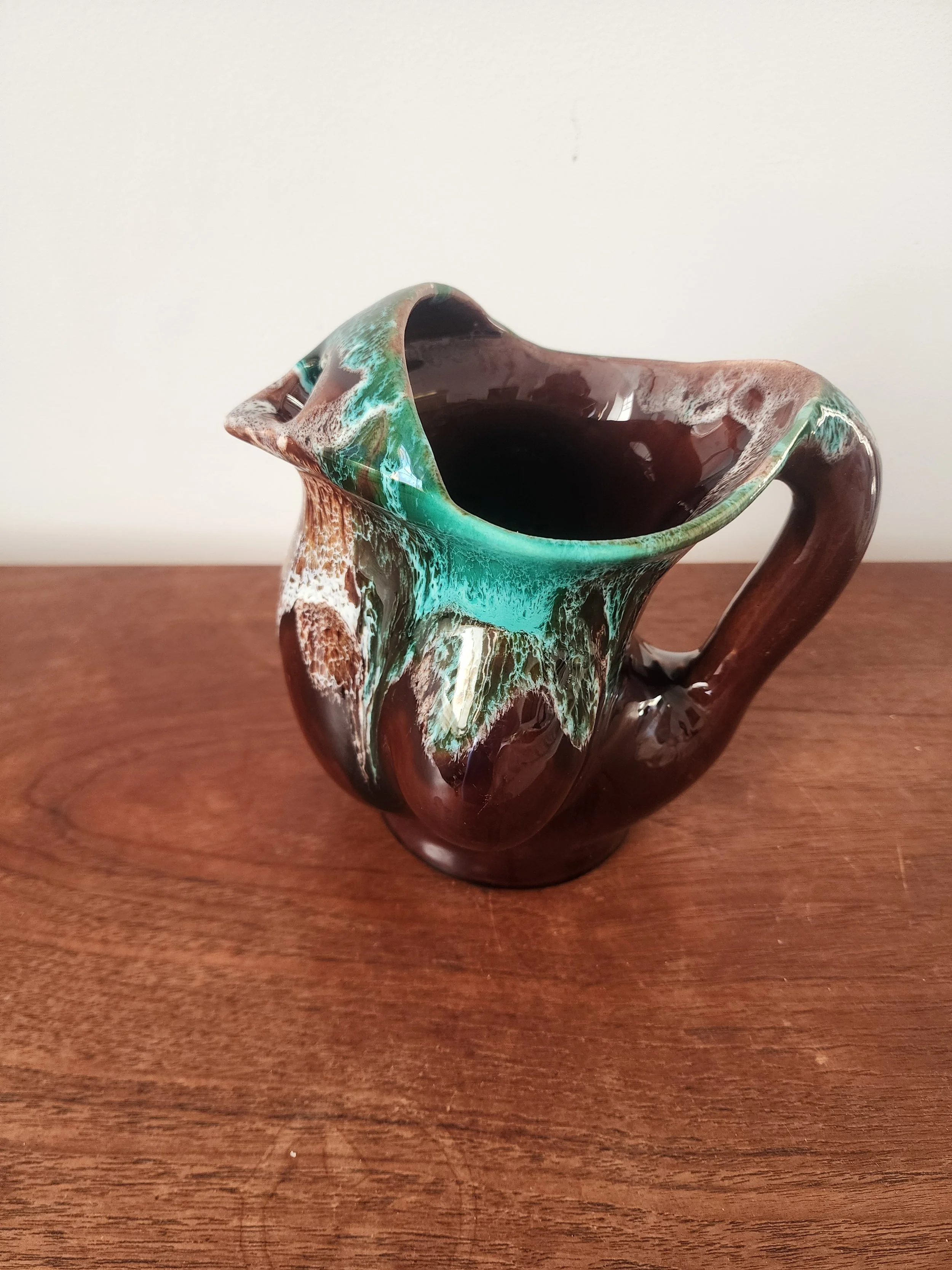 20251212_092846.side view of brown green ceramic pitcher with handle
