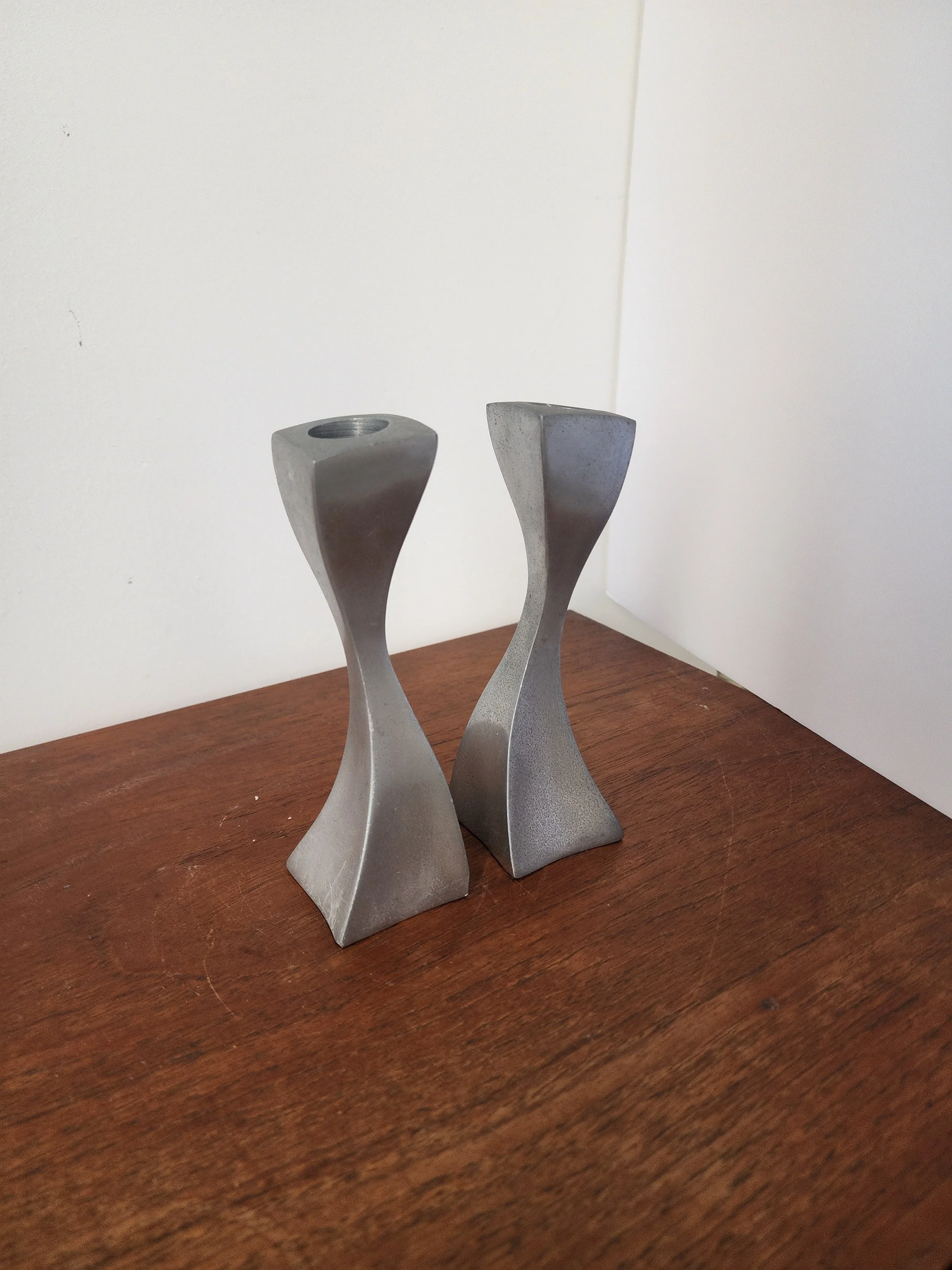 Modernist sculptural candle holders with elegant curves.