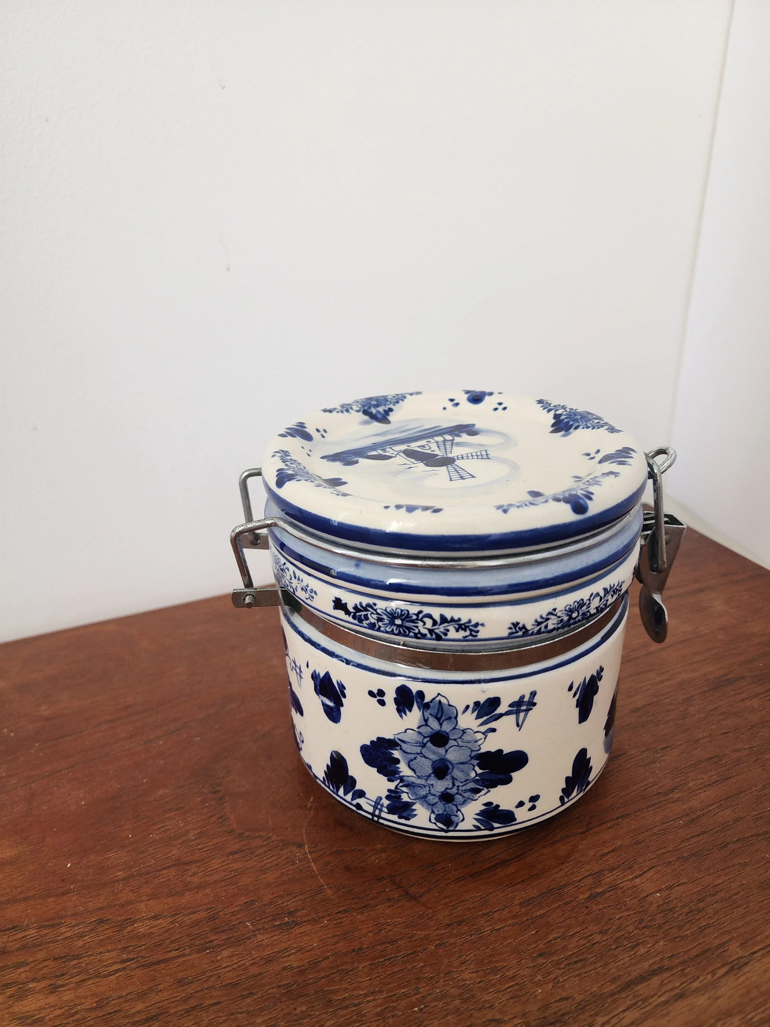 Vintage Delft pottery kitchen jar in natural light.
