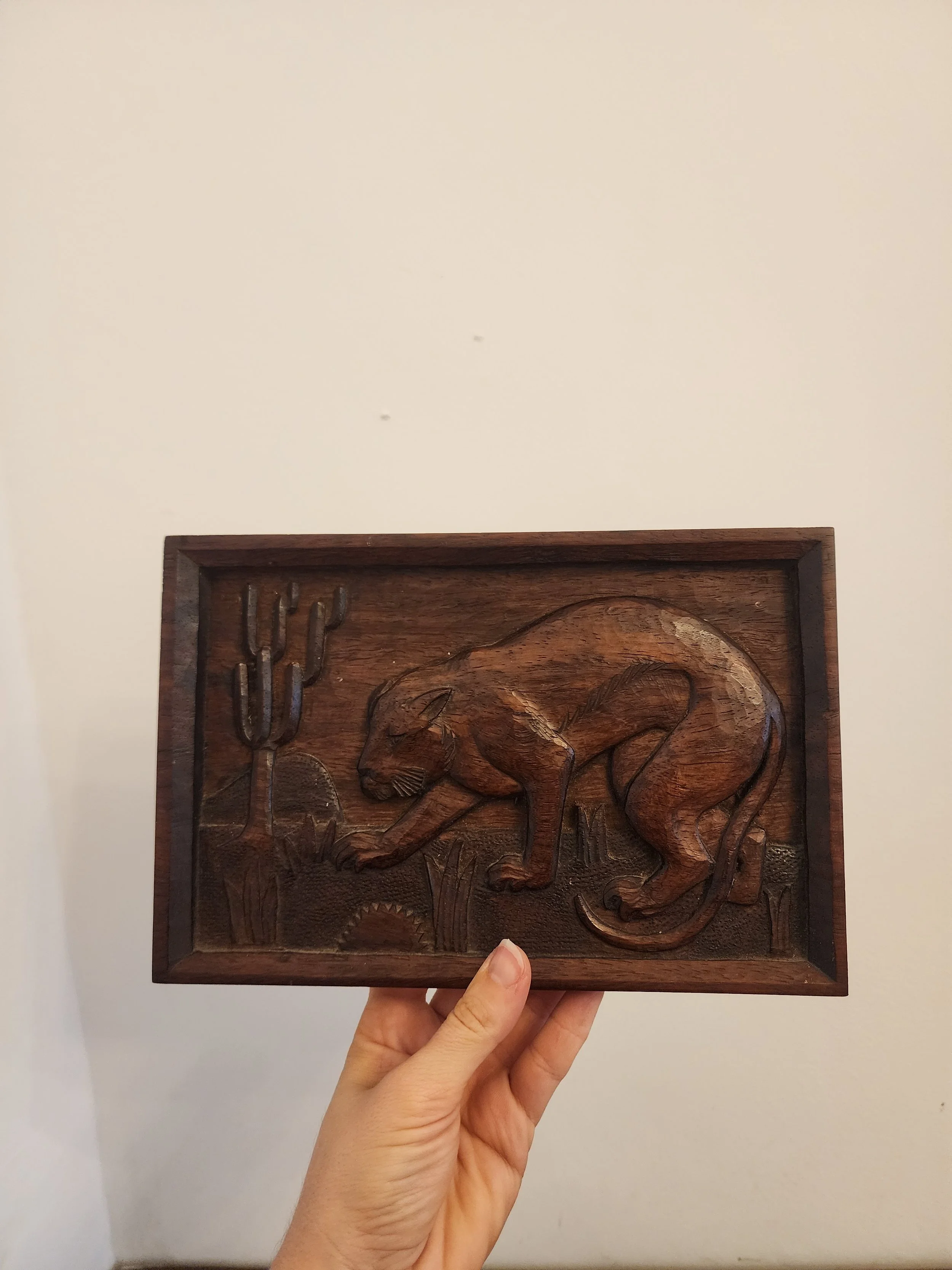 Mid-century carved wood panel with animal design.