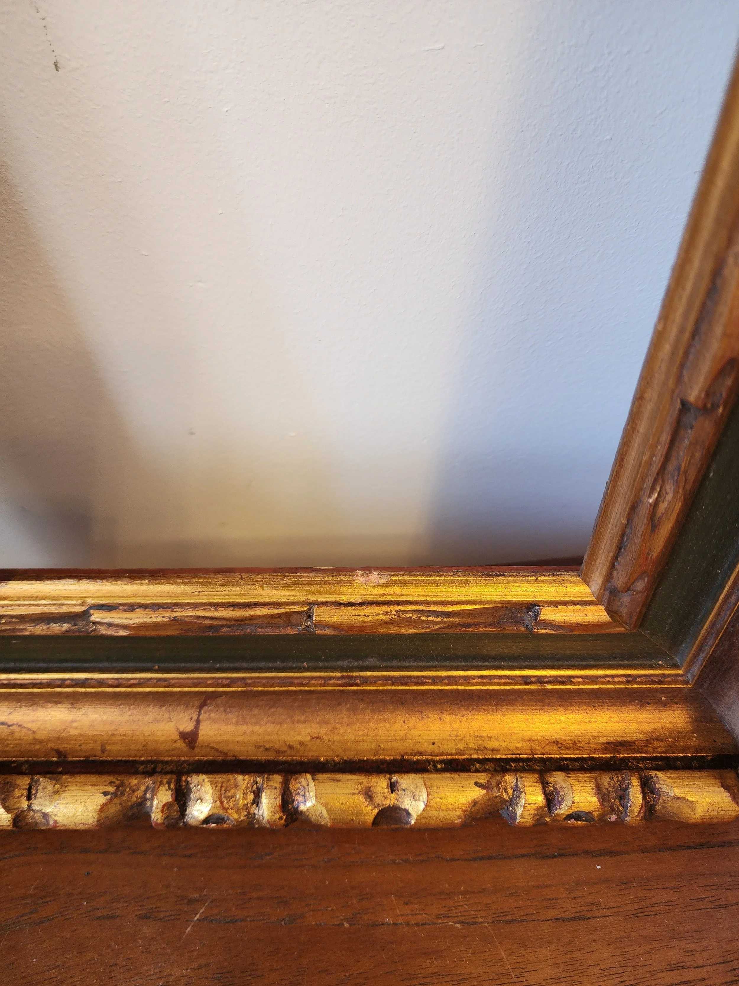 angled view of ornate wooden frame showing depth and profile