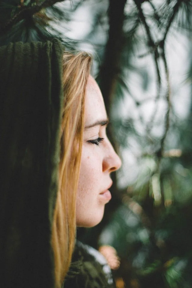 A calm woman surrounded by soft natural light and greenery, representing reflection, healing, and emotional wellbeing through depression counselling at Self Growth Institute, Melbourne.