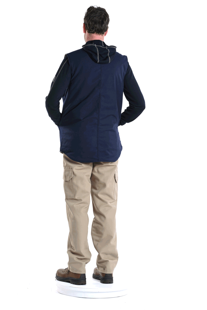 Back view of a man wearing a navy jacket, beige cargo pants, and brown shoes, standing on a white circular platform against a white background.