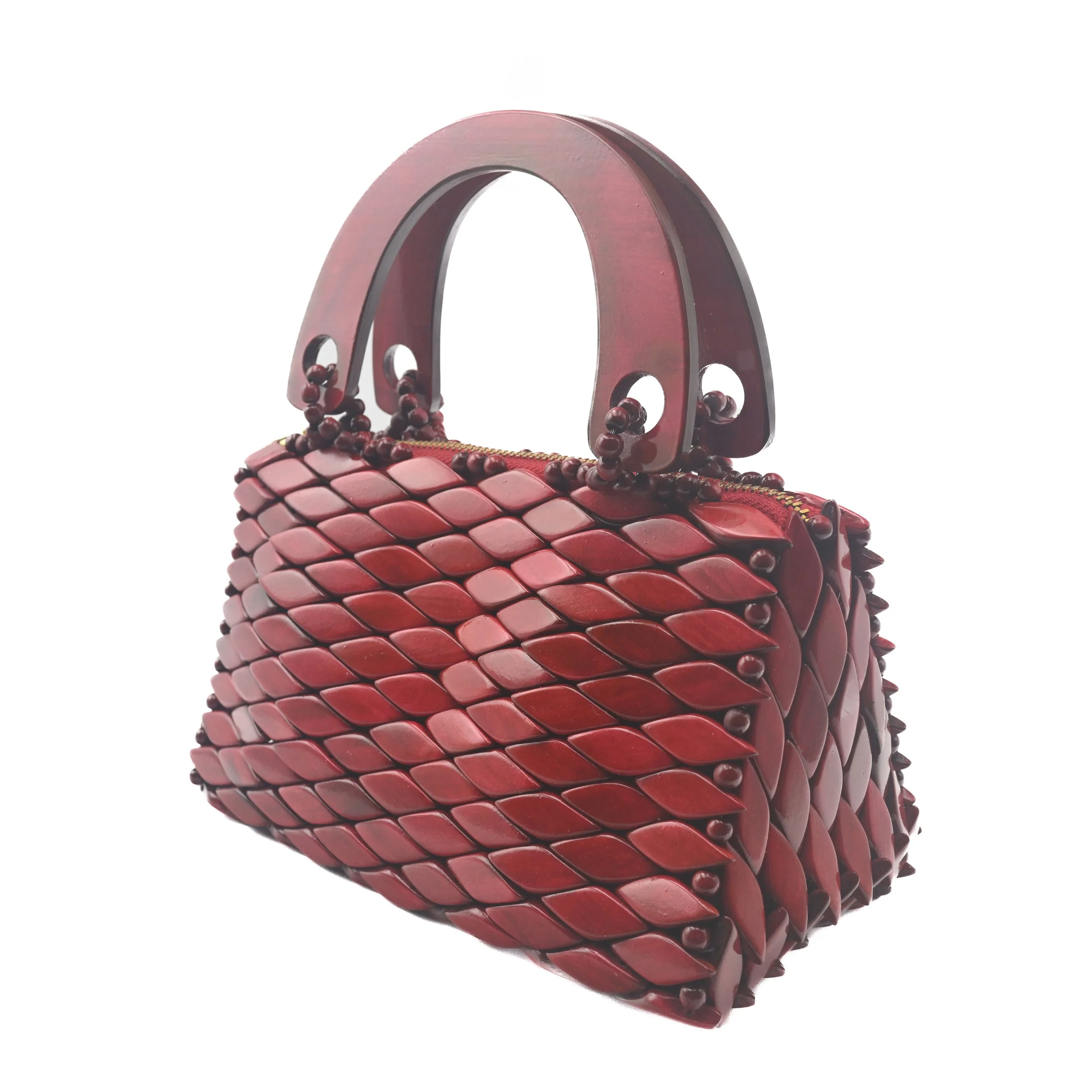 A red handbag with a woven leather design and a large, curved handle.
