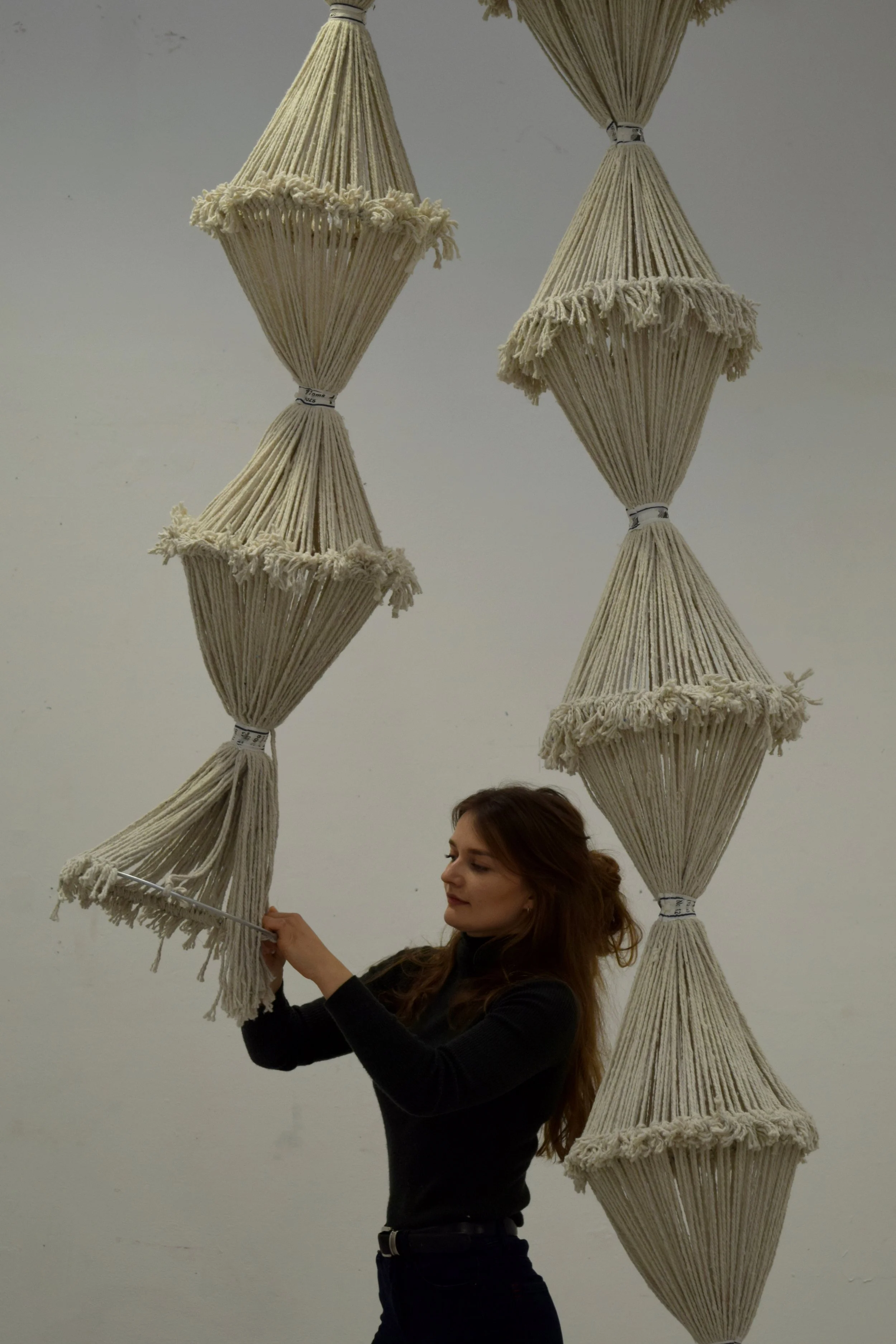 Macrame artist and sculptor Lucy Wayman working on a giant rope sculpture
