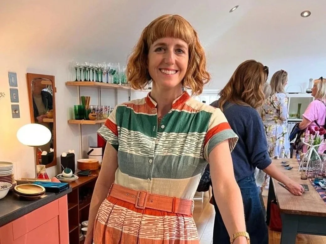 Zoe, owner of Jimmys Homeware smiling while people shop behind her at her homeware takeover of The Arienas Collective