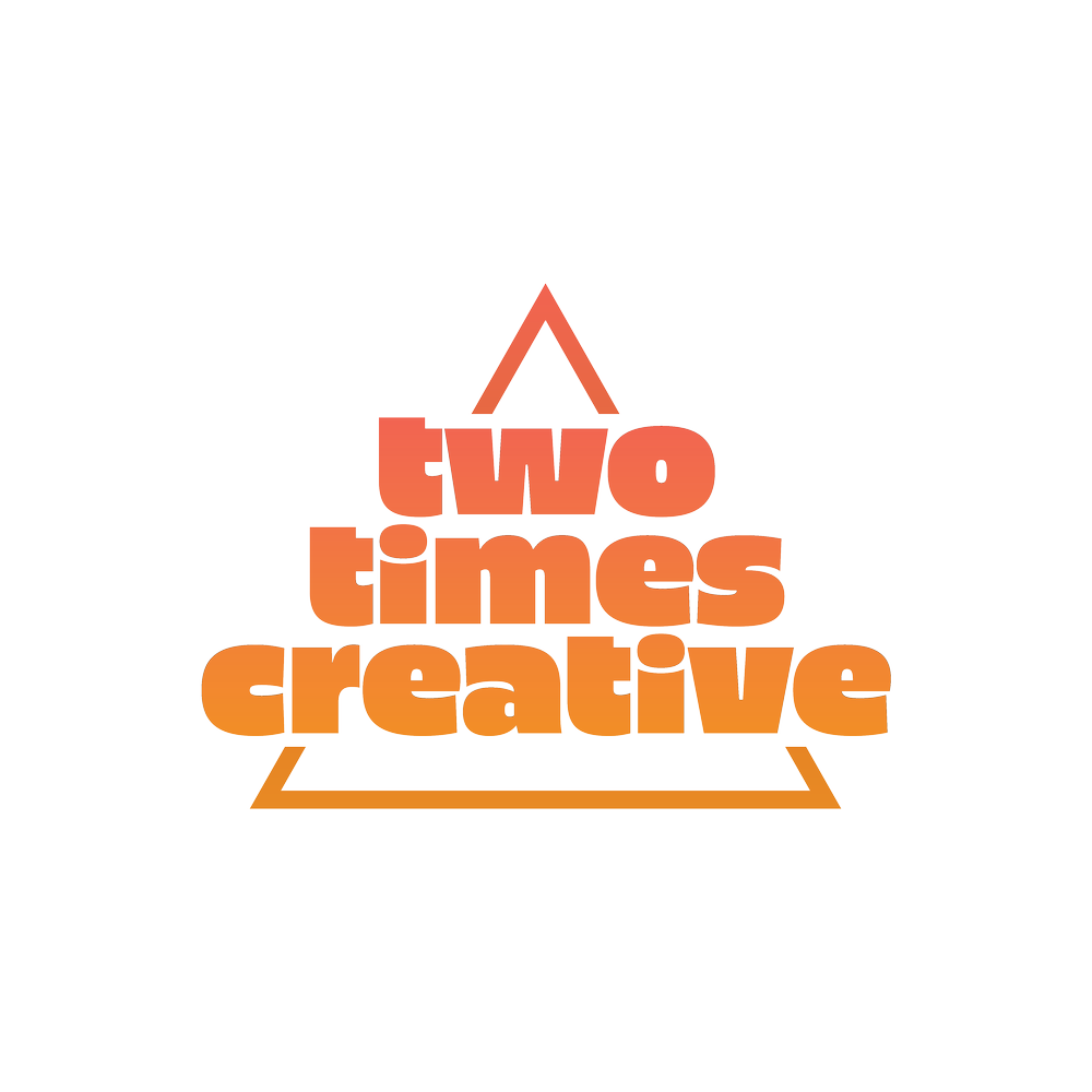 The image features a triangular shape with the words "two times creative" arranged inside it in bold, orange letters, set against a transparent background.