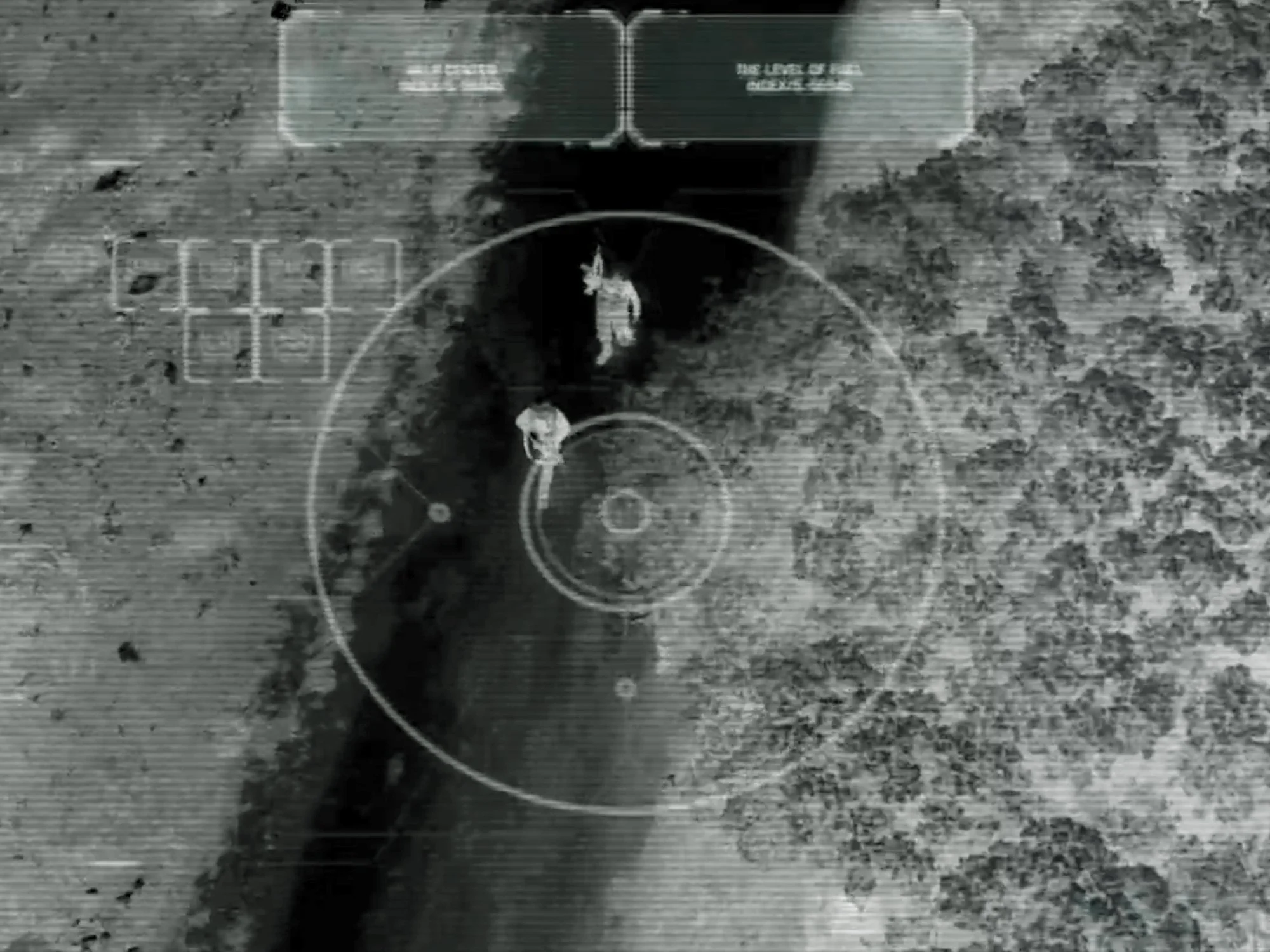 Black and white aerial drone image showing two soldiers walking in a trench with discovery grid overlay.