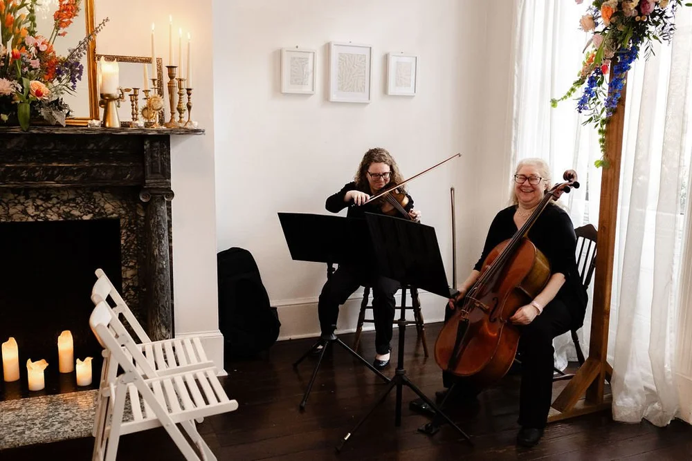 Live string musicians performing inside Vaux Studio
