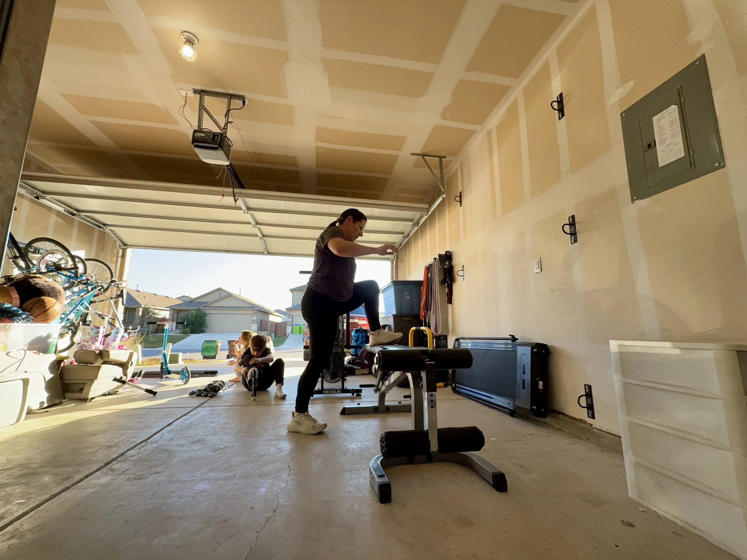 a mom of 4 working out in her garage gym using minimal equipment to build muscle