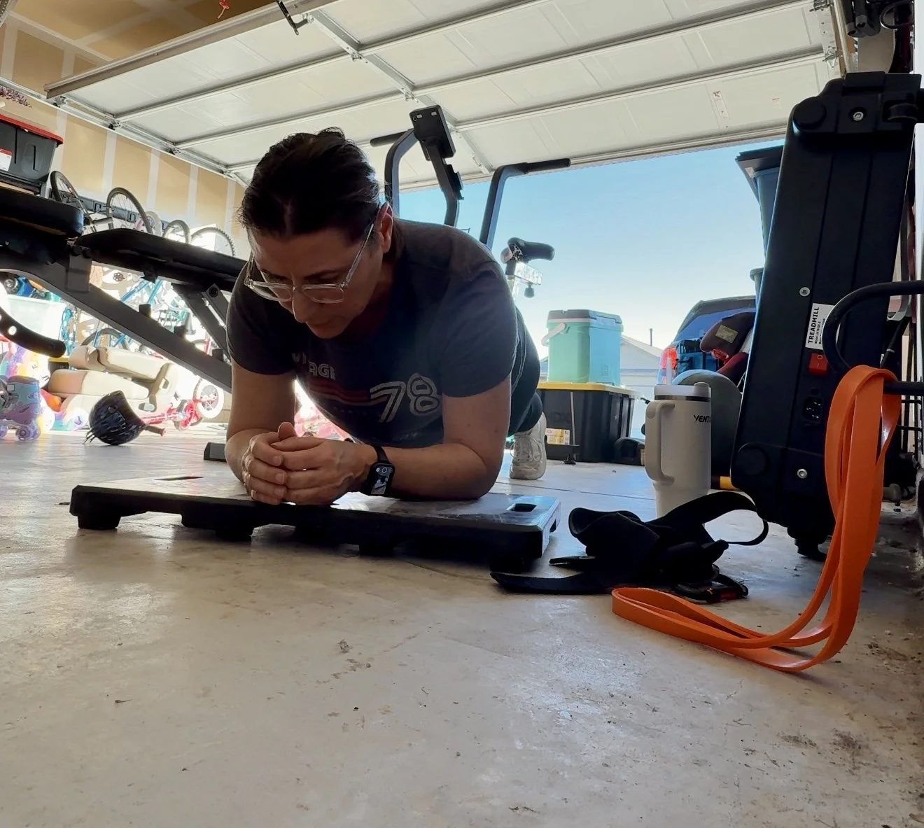 a 48-year-old mom of 4 working out in her garage gym to build muscle and core strength