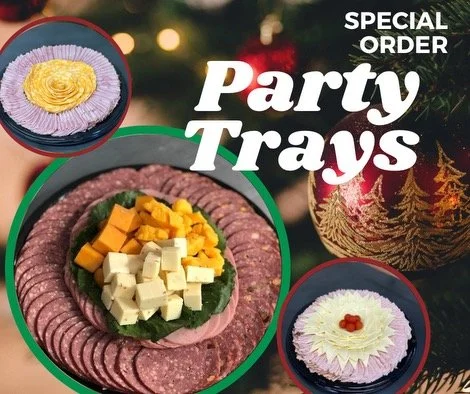 Elm Creek Beef Party trays with assorted cheese and meat slices and decorated desserts, with Christmas-themed background
