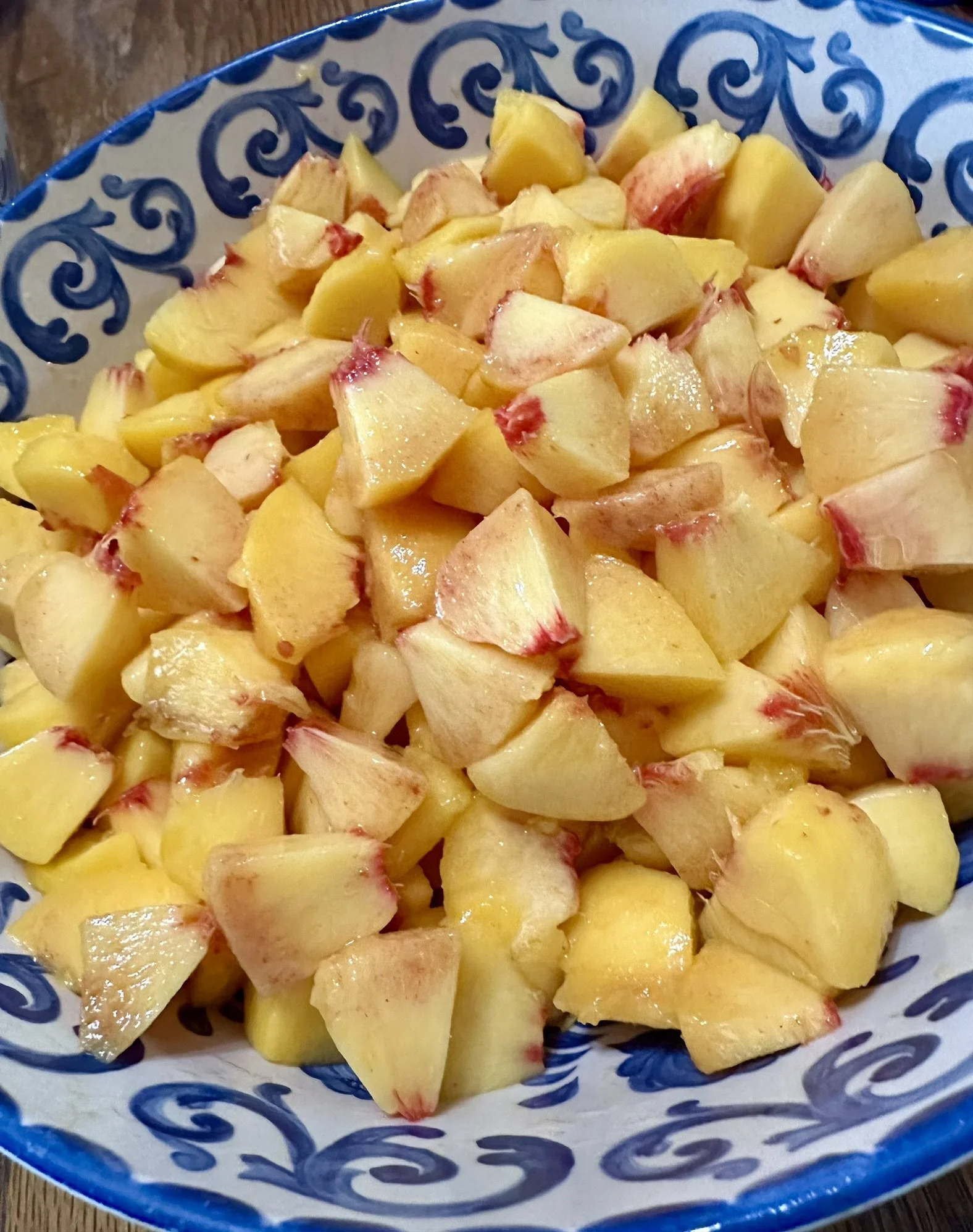 Elm Creek Beef Chopped peaches in a blue and white patterned bowl.