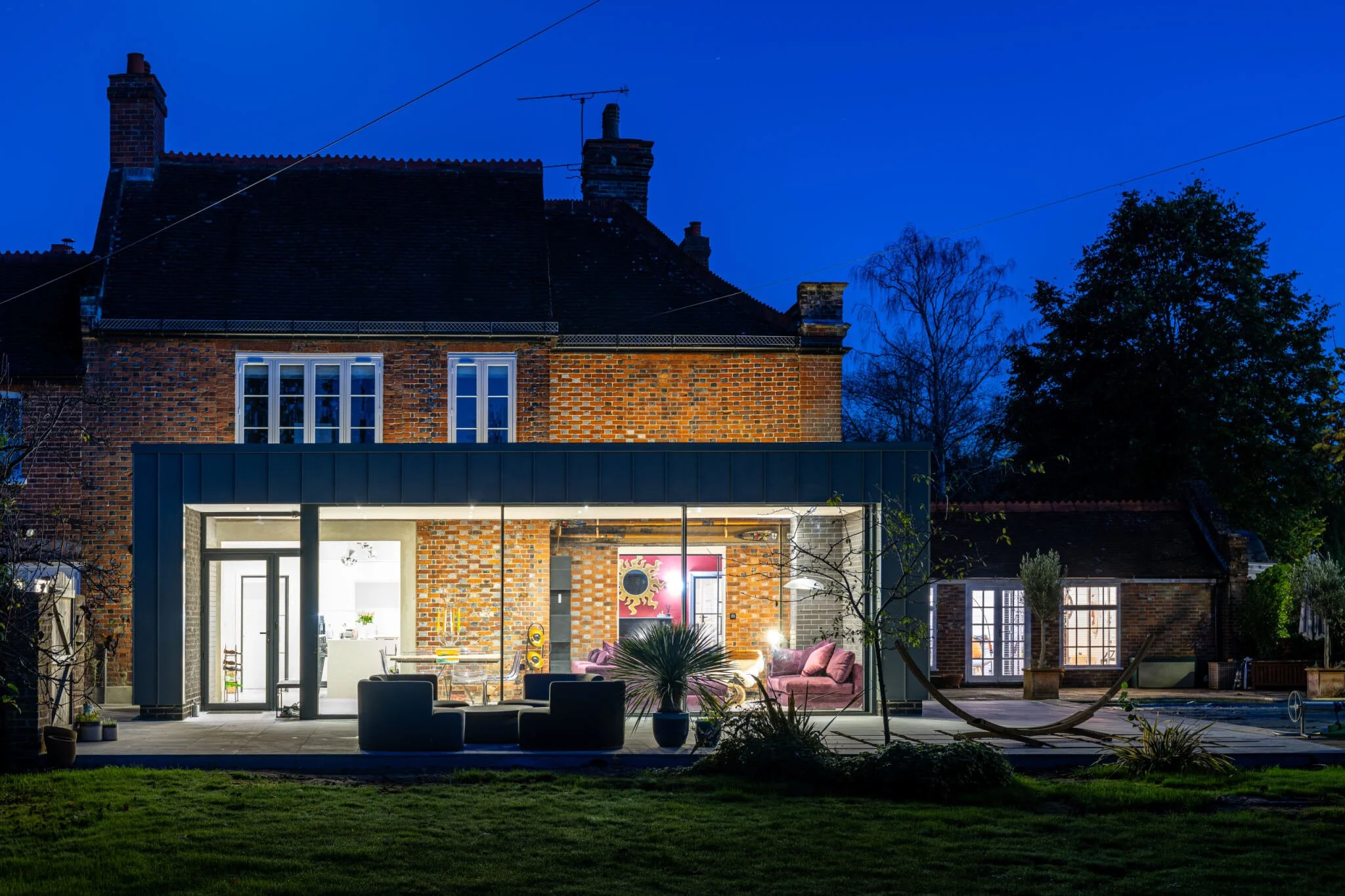 Best builder in surrey modern - period home extension at night
