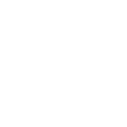 A slice of bread with a butter knife spreading butter on it.