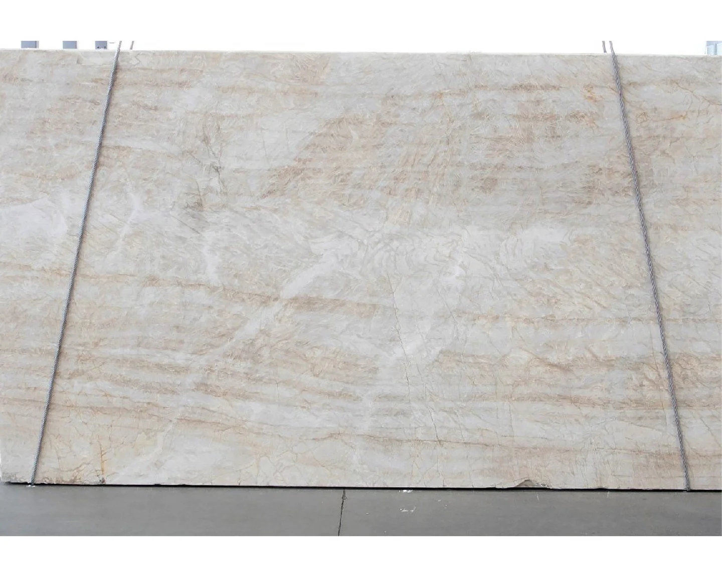 Quartzite Naica, quarried in Brazil, reveals a soft interplay of creams and silvery grays with delicate veining that moves gently across the surface. Renowned for its strength and subtle translucence, this quartzite pairs durability with sophisticati